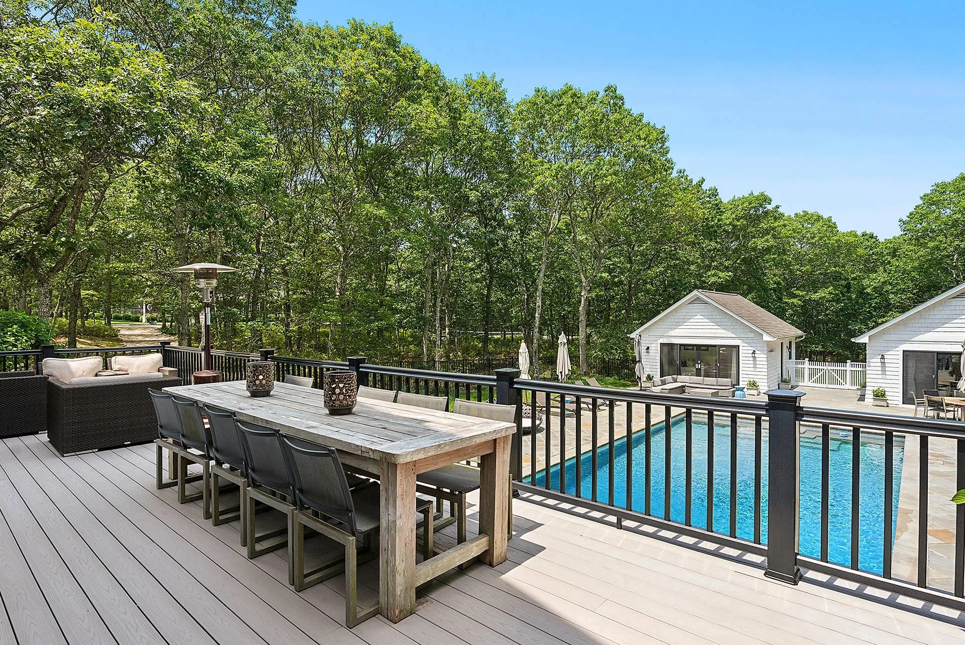 Wooden deck with an outdoor living space, outdoor dining area, an outbuilding, and a patio Wooden deck with an outdoor living space, outdoor dining area, an outbuilding, and a patio