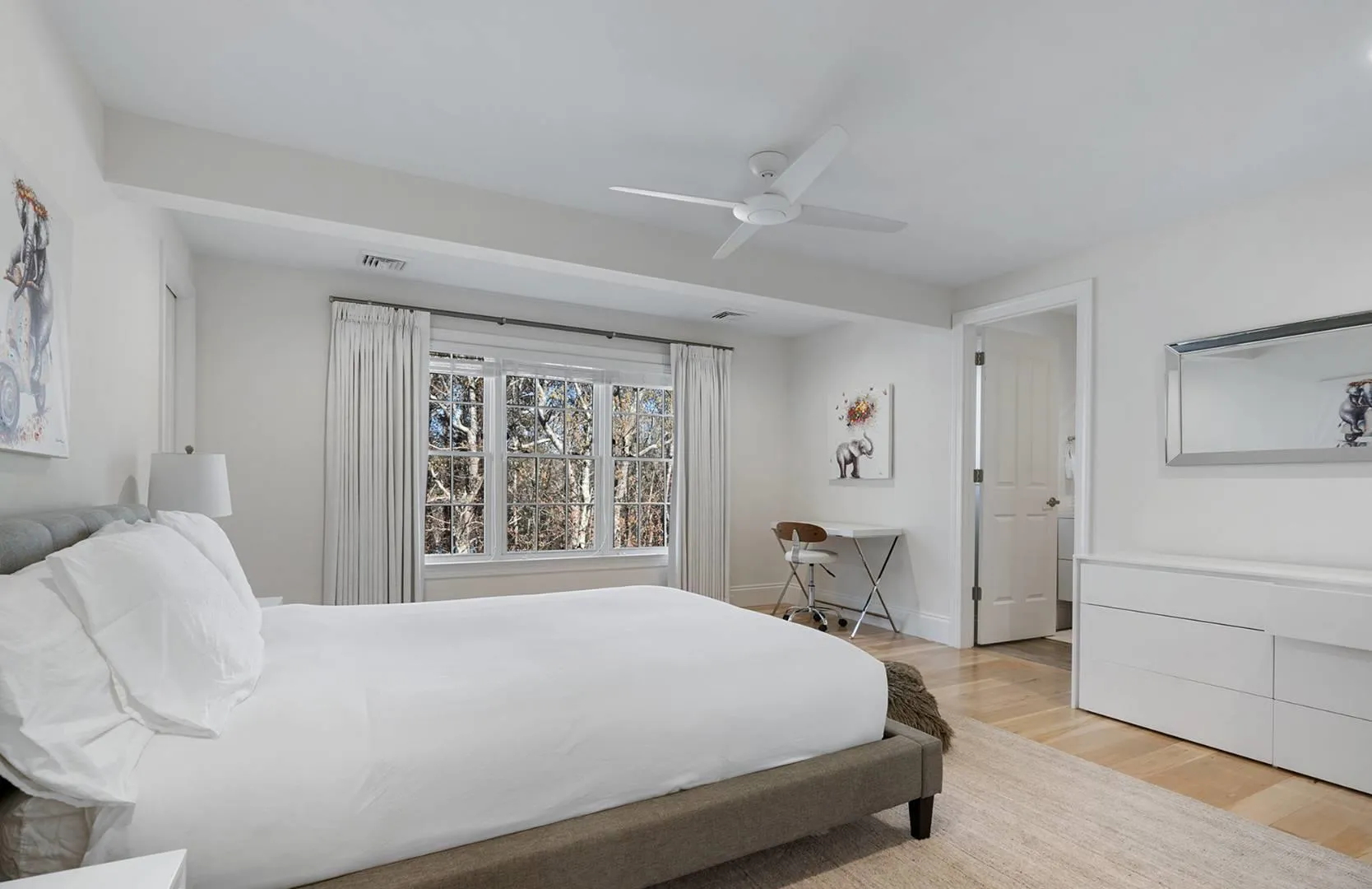 Bedroom featuring light wood-style flooring and ceiling fan Bedroom featuring light wood-style flooring and ceiling fan