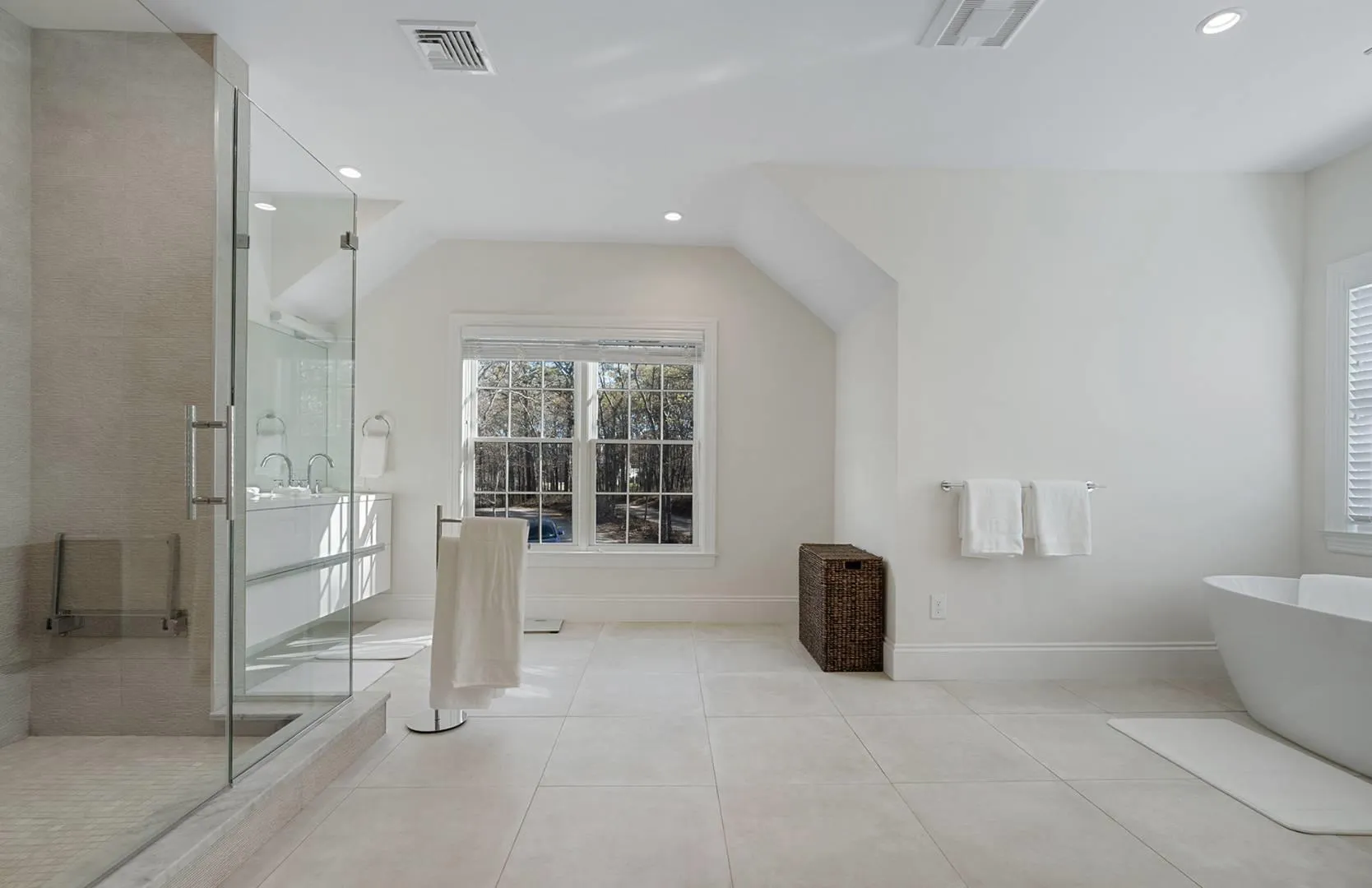Full bath featuring a freestanding tub, a shower stall, tile patterned flooring, recessed lighting, and vaulted ceiling Full bath featuring a freestanding tub, a shower stall, tile patterned flooring, recessed lighting, and vaulted ceiling