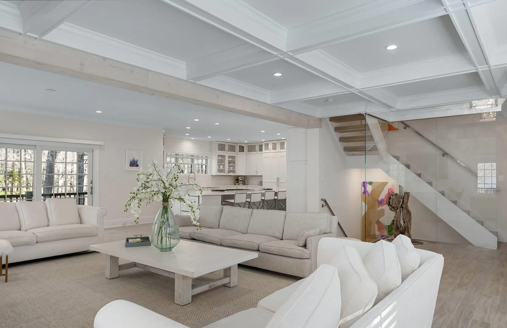 Living room featuring plenty of natural light, stairway, beamed ceiling, crown molding, and recessed lighting Living room featuring plenty of natural light, stairway, beamed ceiling, crown molding, and recessed lighting