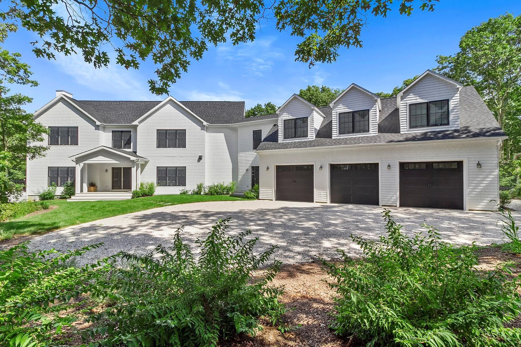 View of front of house with driveway, a shingled roof, and a garage View of front of house with driveway, a shingled roof, and a garage