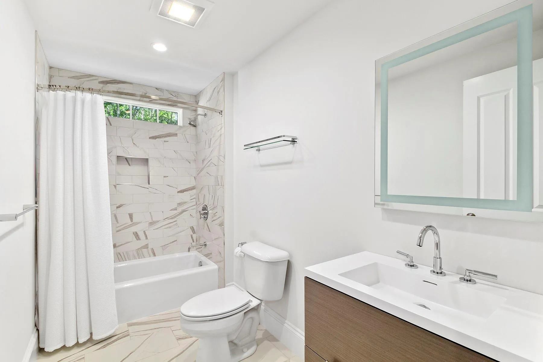 Bathroom featuring vanity and shower / bath combination with curtain Bathroom featuring vanity and shower / bath combination with curtain