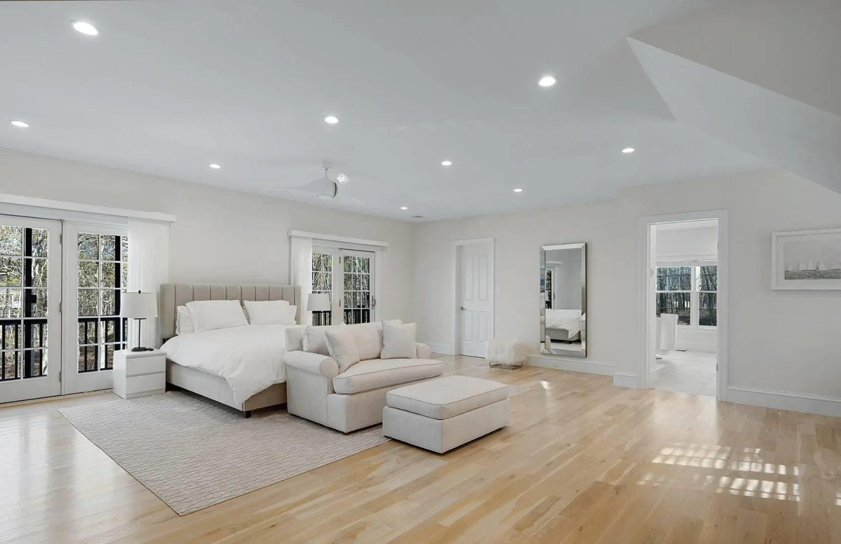 Bedroom with access to outside, multiple windows, light wood-type flooring, and recessed lighting Bedroom with access to outside, multiple windows, light wood-type flooring, and recessed lighting