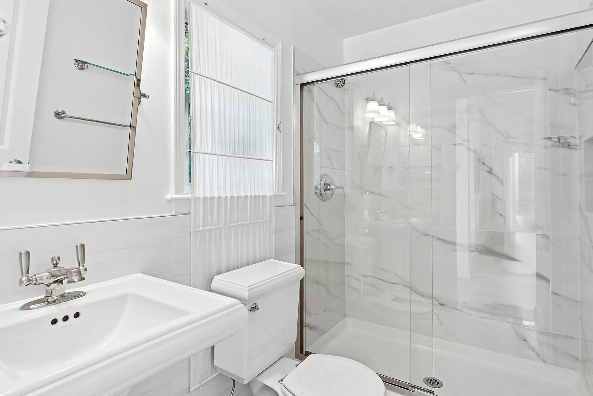 Bathroom featuring toilet and a marble finish shower Bathroom featuring toilet and a marble finish shower