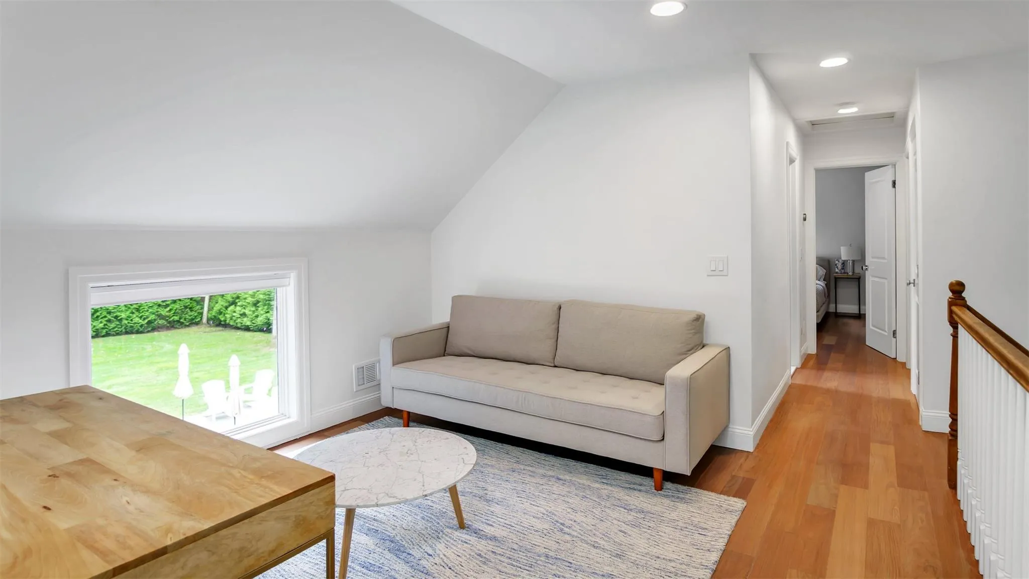 Living room with vaulted ceiling and light wood-type flooring Living room with vaulted ceiling and light wood-type flooring
