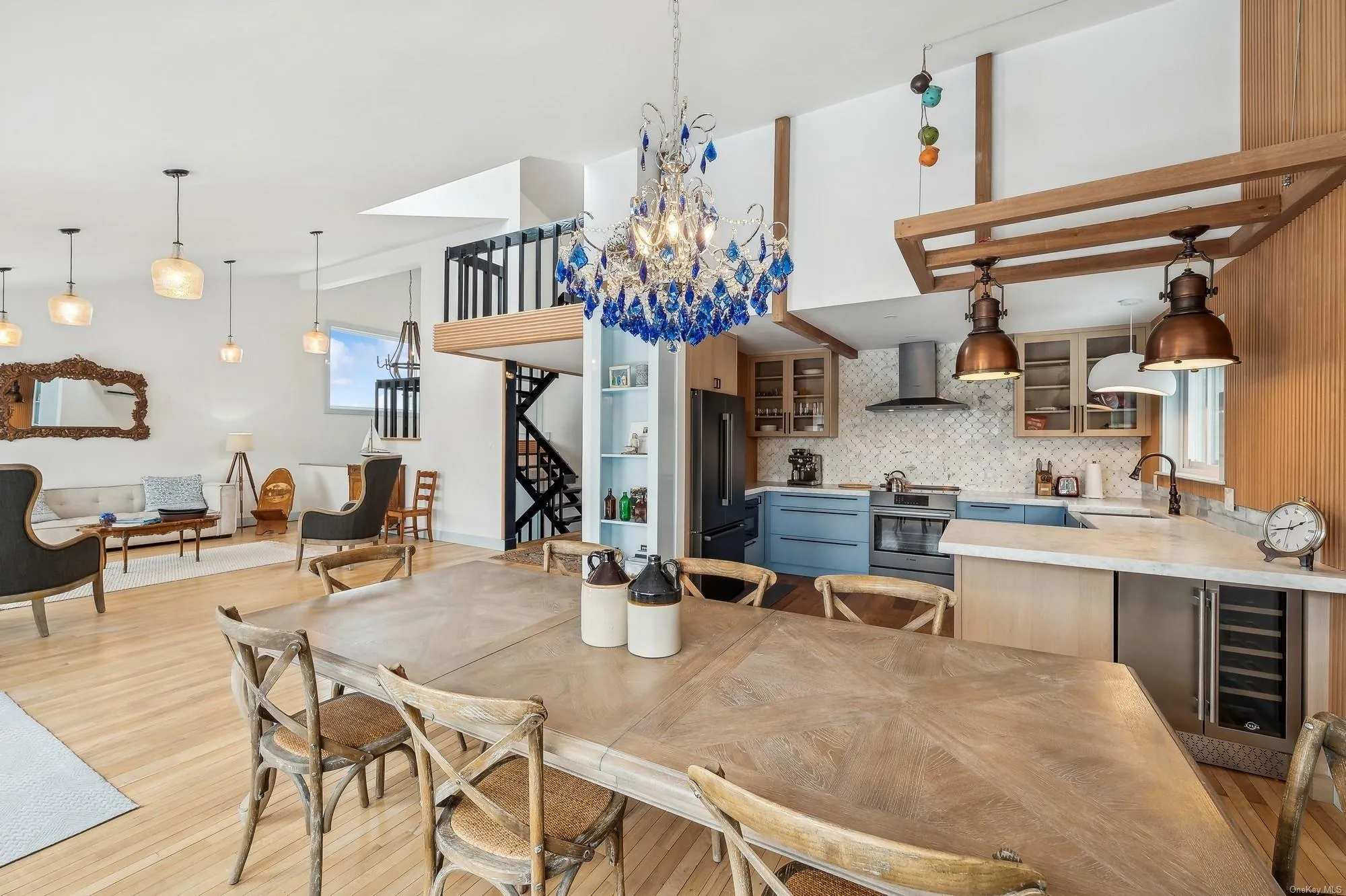 Dining area featuring light wood-type flooring, beverage cooler, OPEN LIVING Dining area featuring light wood-type flooring, beverage cooler, OPEN LIVING