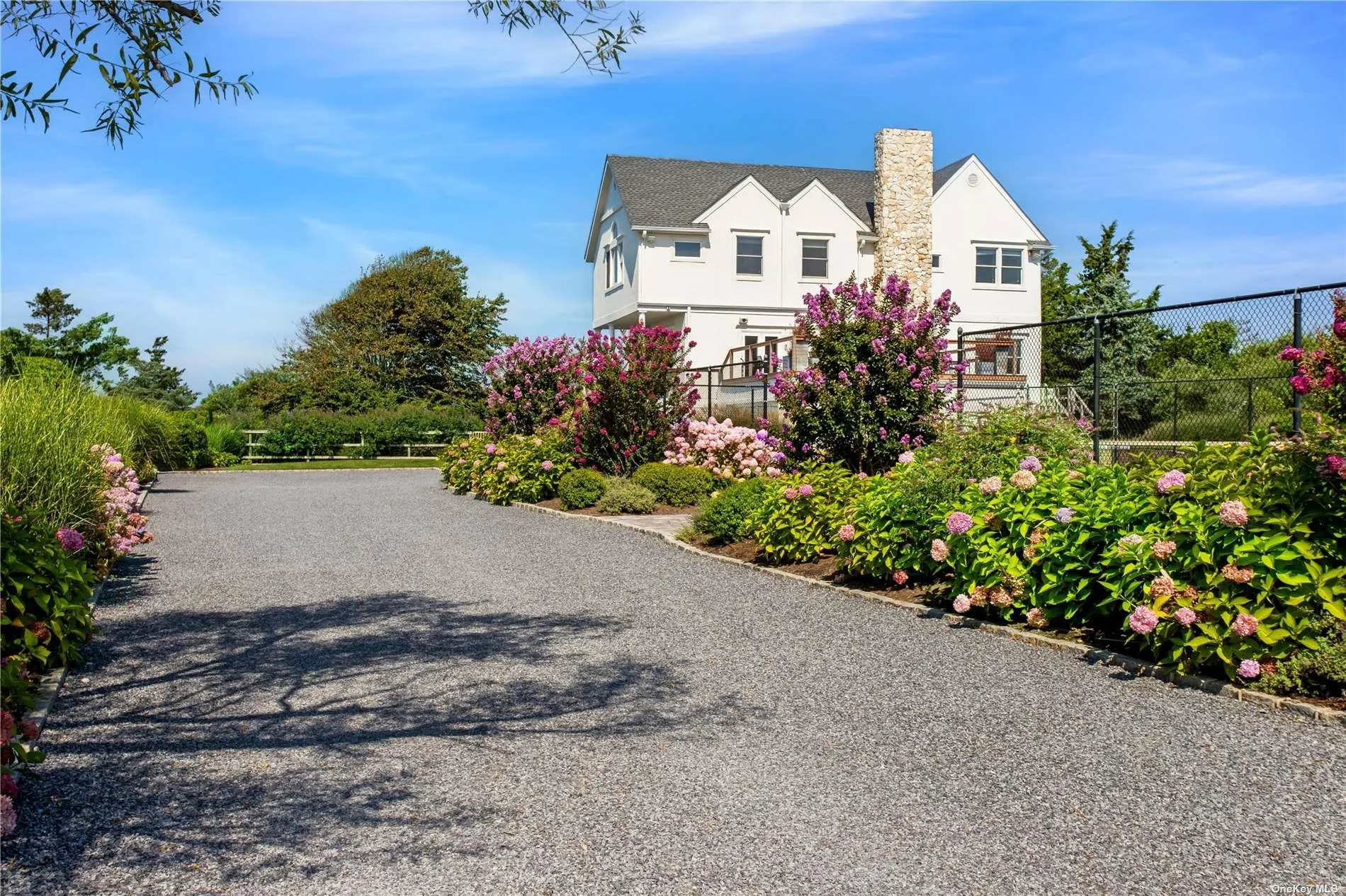 Private drive surrounded by colorful gardens Private drive surrounded by colorful gardens