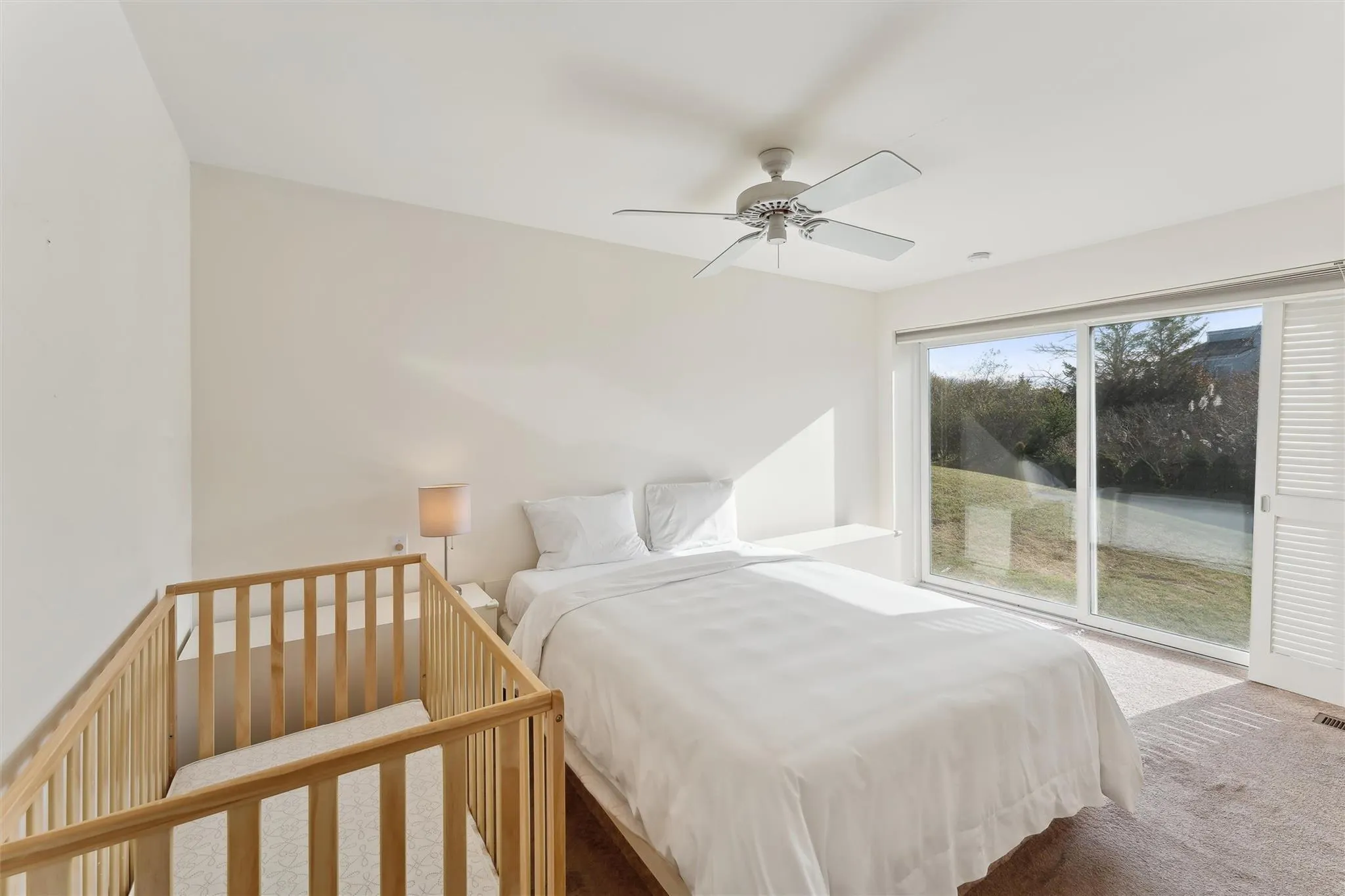 Bedroom with ceiling fan, carpet floors, and access to outside Bedroom with ceiling fan, carpet floors, and access to outside
