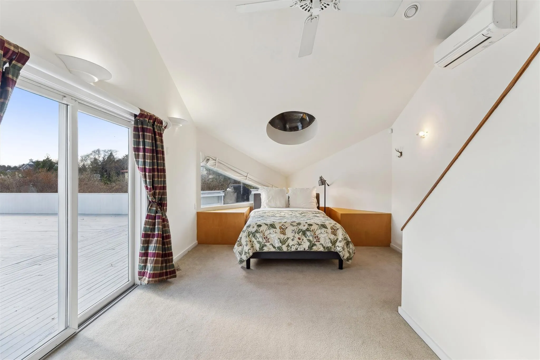 Bedroom with ceiling fan, a wall mounted AC, access to outside, and multiple windows Bedroom with ceiling fan, a wall mounted AC, access to outside, and multiple windows