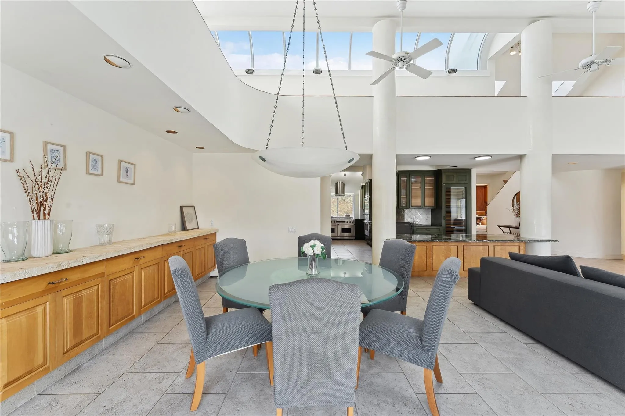 Dining room with ceiling fan and a towering ceiling Dining room with ceiling fan and a towering ceiling