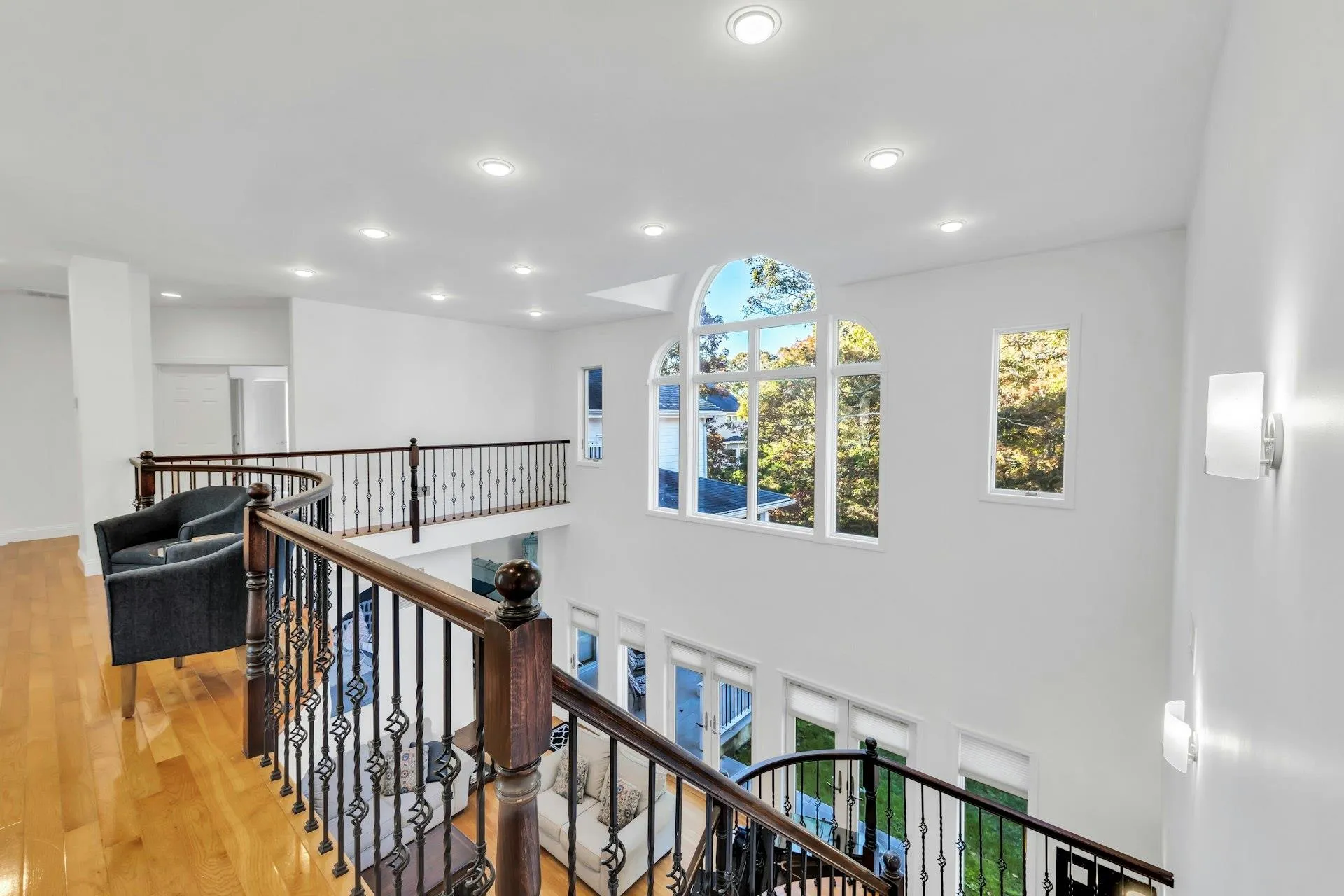 Hall with healthy amount of natural light, hardwood / wood-style flooring, recessed lighting, and an upstairs landing Hall with healthy amount of natural light, hardwood / wood-style flooring, recessed lighting, and an upstairs landing