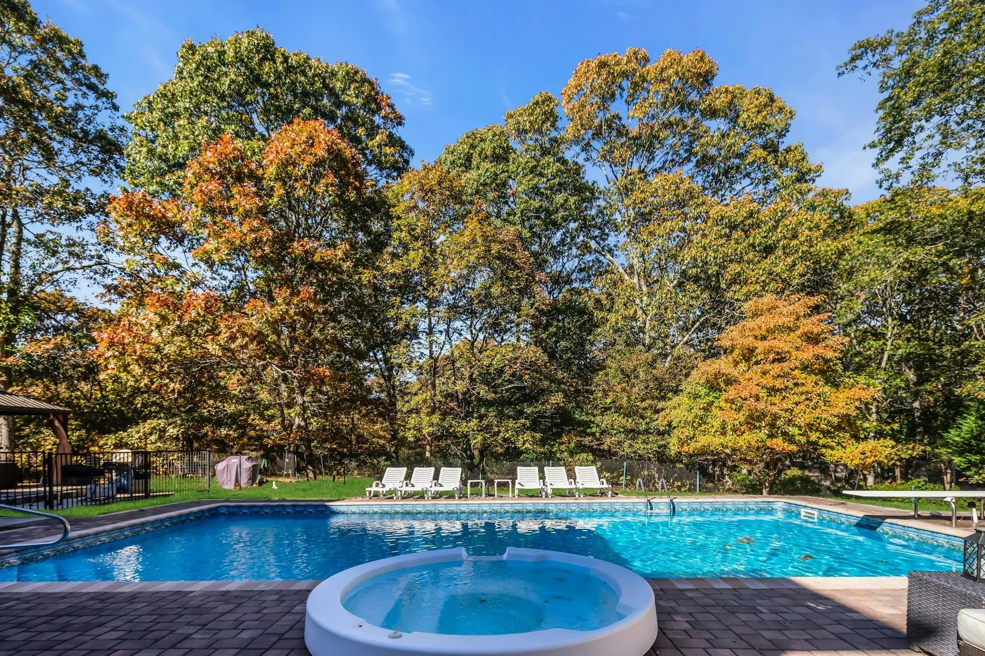View of pool featuring a patio area and an in-ground hot tub View of pool featuring a patio area and an in-ground hot tub