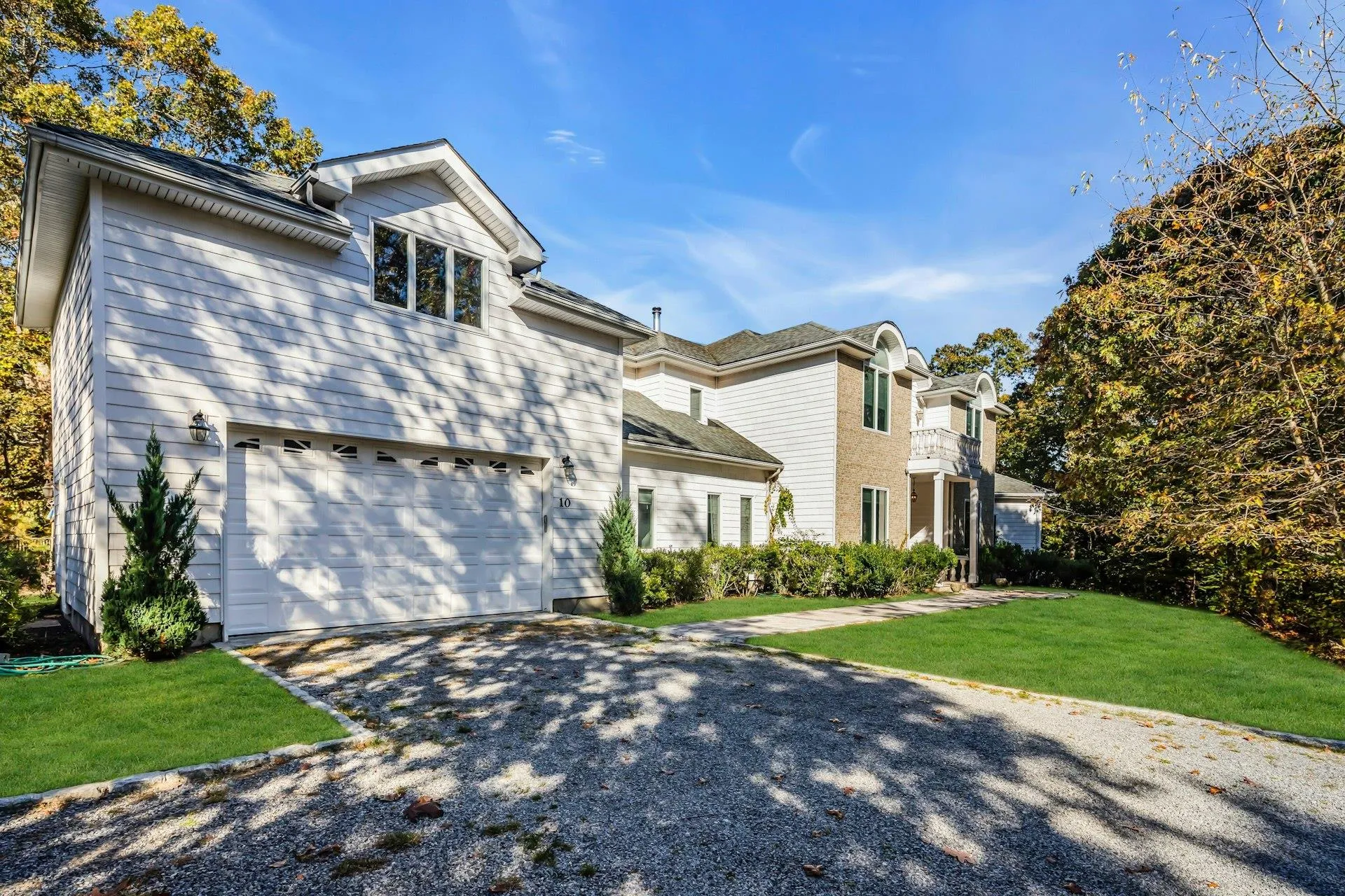 View of front facade featuring driveway, a front yard, and a garage View of front facade featuring driveway, a front yard, and a garage