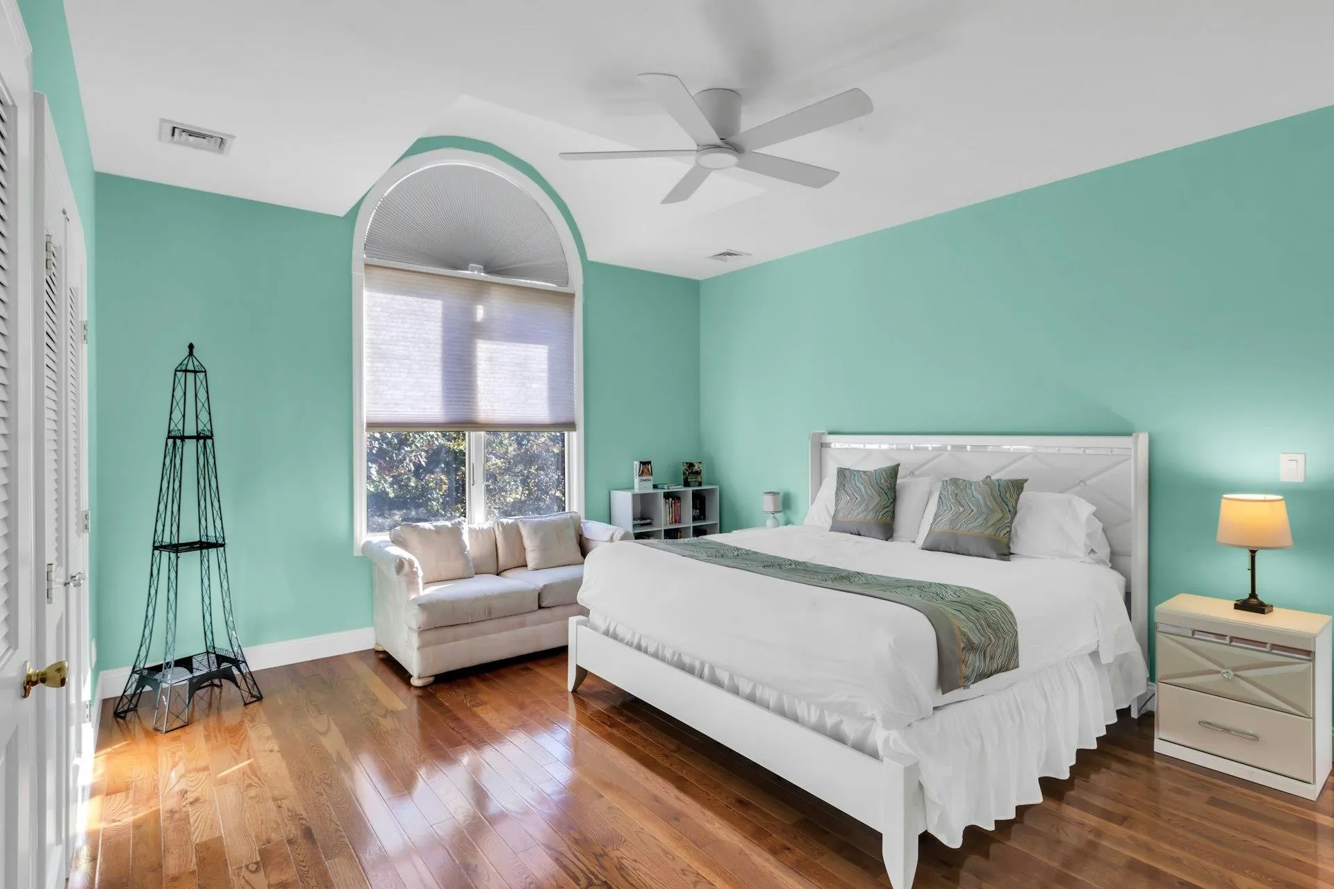 Bedroom with wood-type flooring and a ceiling fan Bedroom with wood-type flooring and a ceiling fan