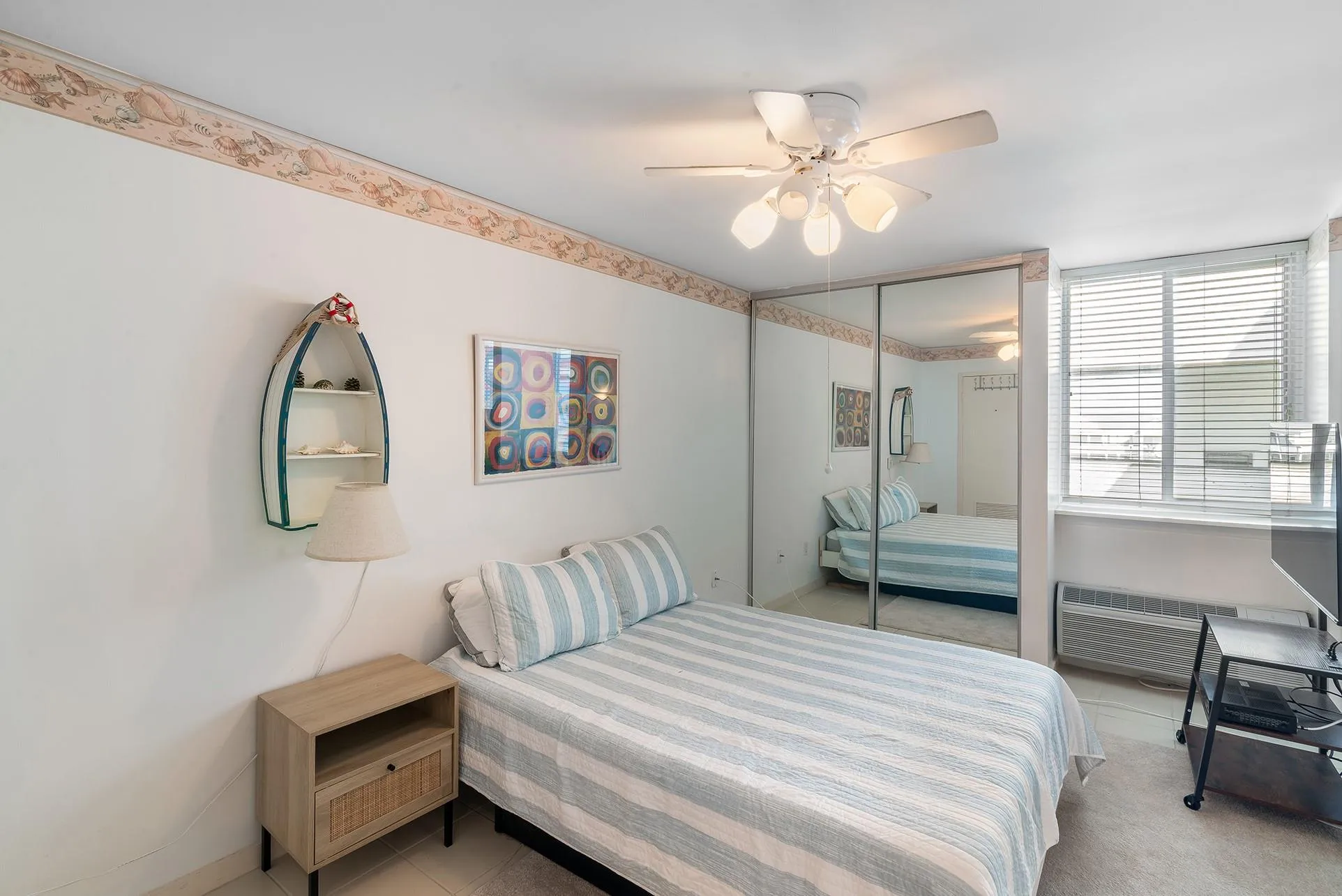 Bedroom with a closet, a ceiling fan, and light colored carpet Bedroom with a closet, a ceiling fan, and light colored carpet