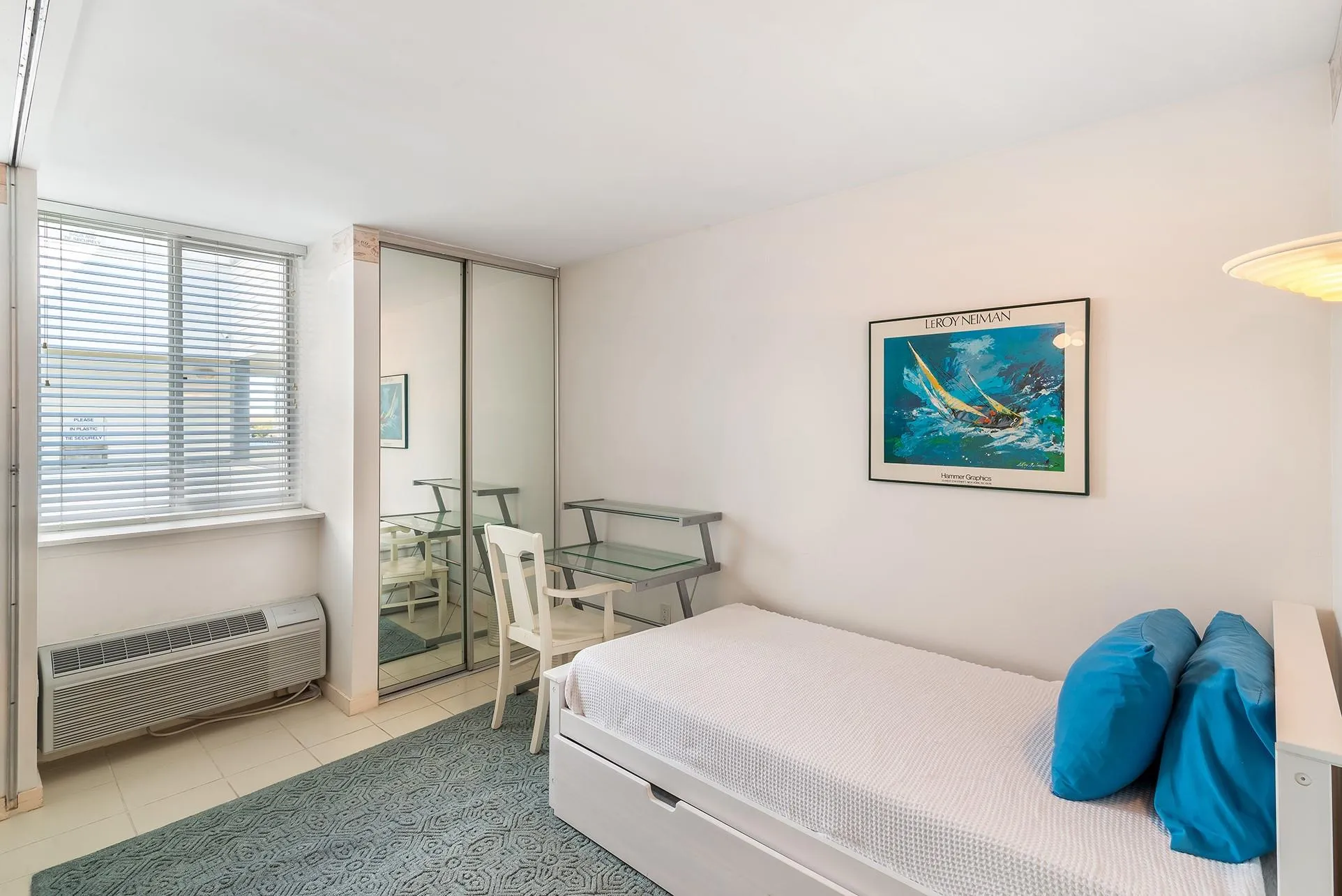 Tiled bedroom featuring a closet and a wall unit AC Tiled bedroom featuring a closet and a wall unit AC