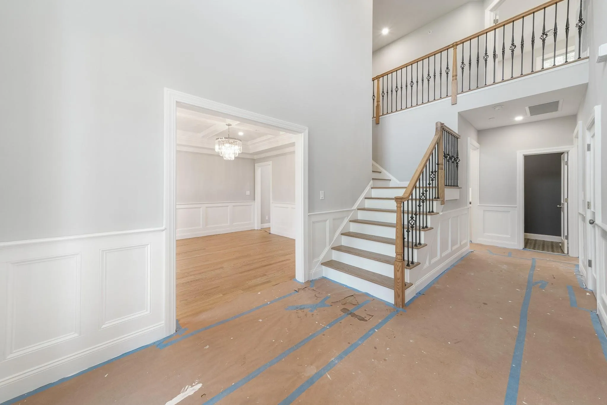 Stairs featuring an inviting chandelier and ornamental molding Stairs featuring an inviting chandelier and ornamental molding