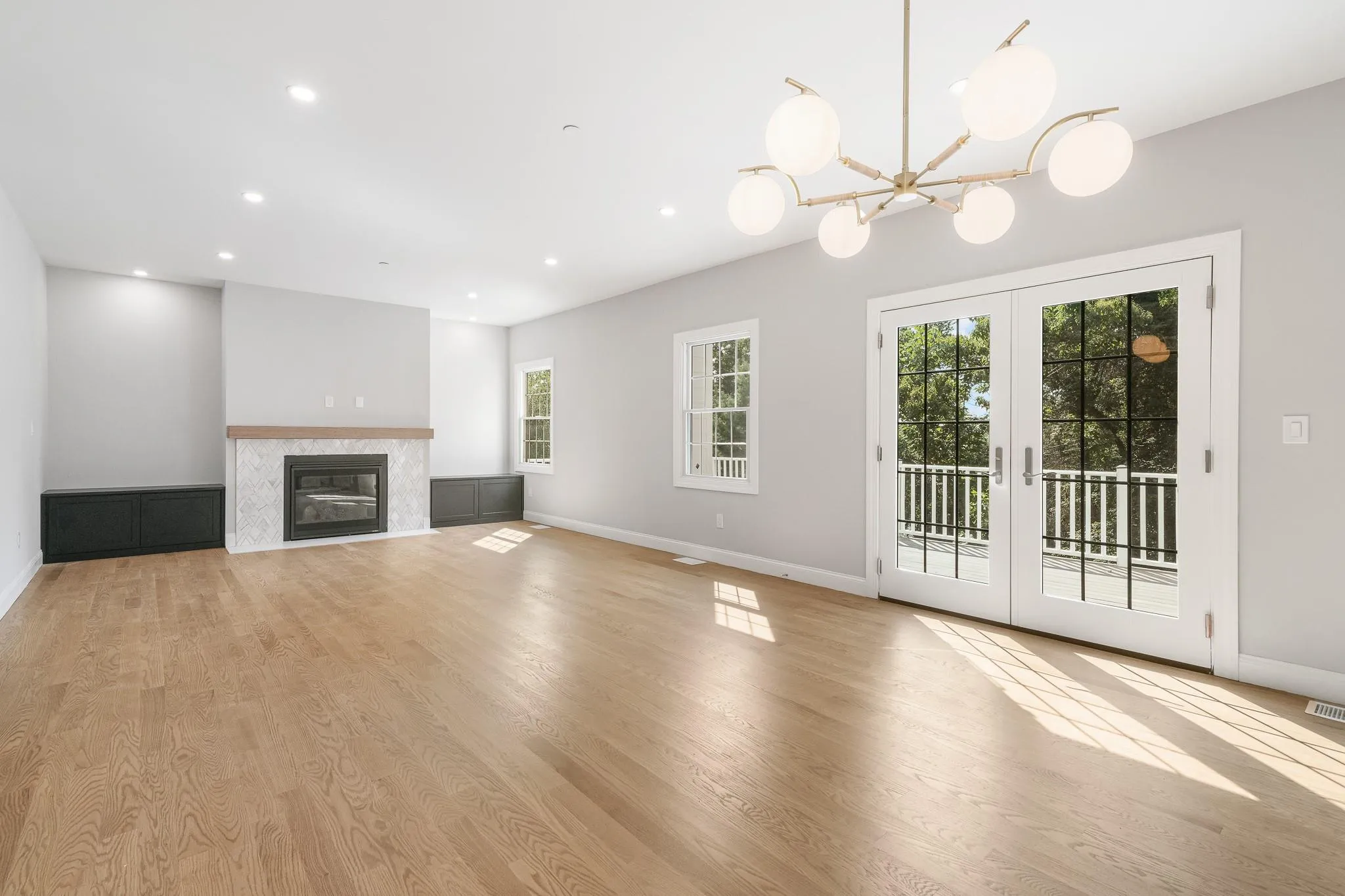 Unfurnished living room with french doors and light hardwood / wood-style flooring Unfurnished living room with french doors and light hardwood / wood-style flooring