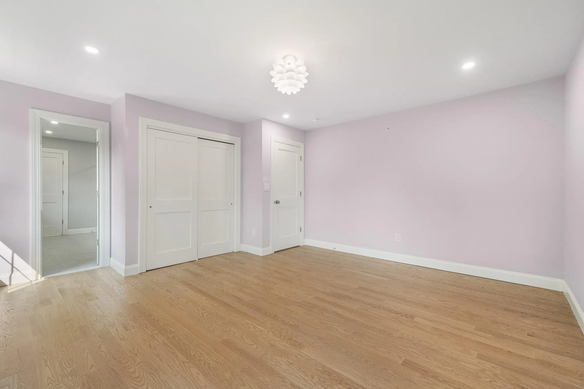 Unfurnished bedroom featuring a closet and light hardwood / wood-style flooring Unfurnished bedroom featuring a closet and light hardwood / wood-style flooring