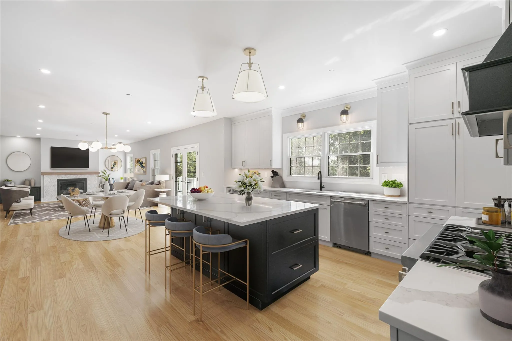 Kitchen with hanging light fixtures, a center island, white cabinets, and appliances with stainless steel finishes Kitchen with hanging light fixtures, a center island, white cabinets, and appliances with stainless steel finishes
