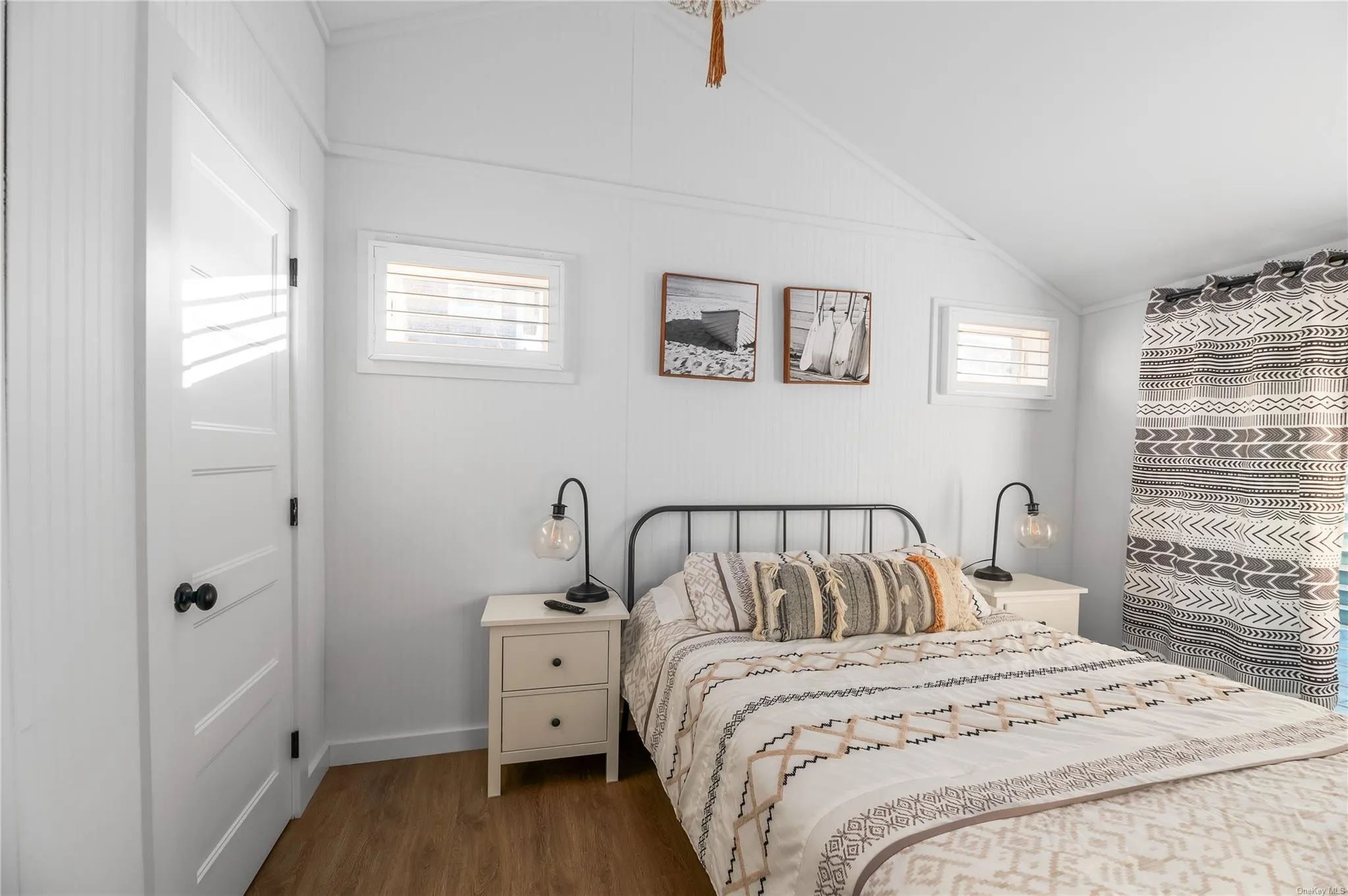 Bedroom with lofted ceiling and dark wood-type flooring Bedroom with lofted ceiling and dark wood-type flooring