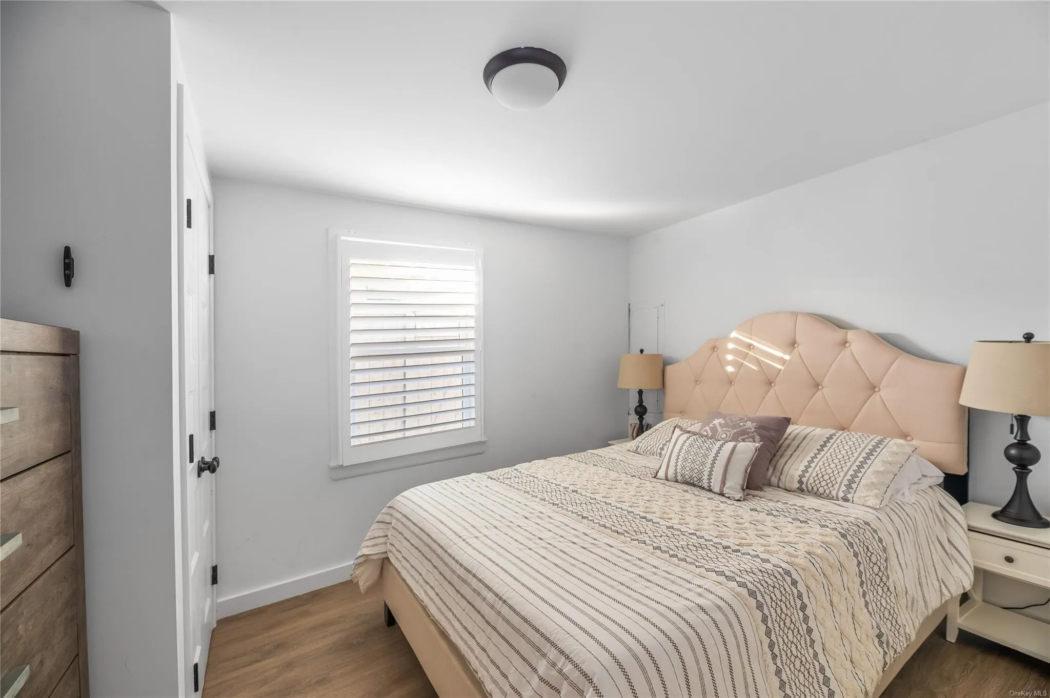 Bedroom featuring dark hardwood / wood-style floors Bedroom featuring dark hardwood / wood-style floors