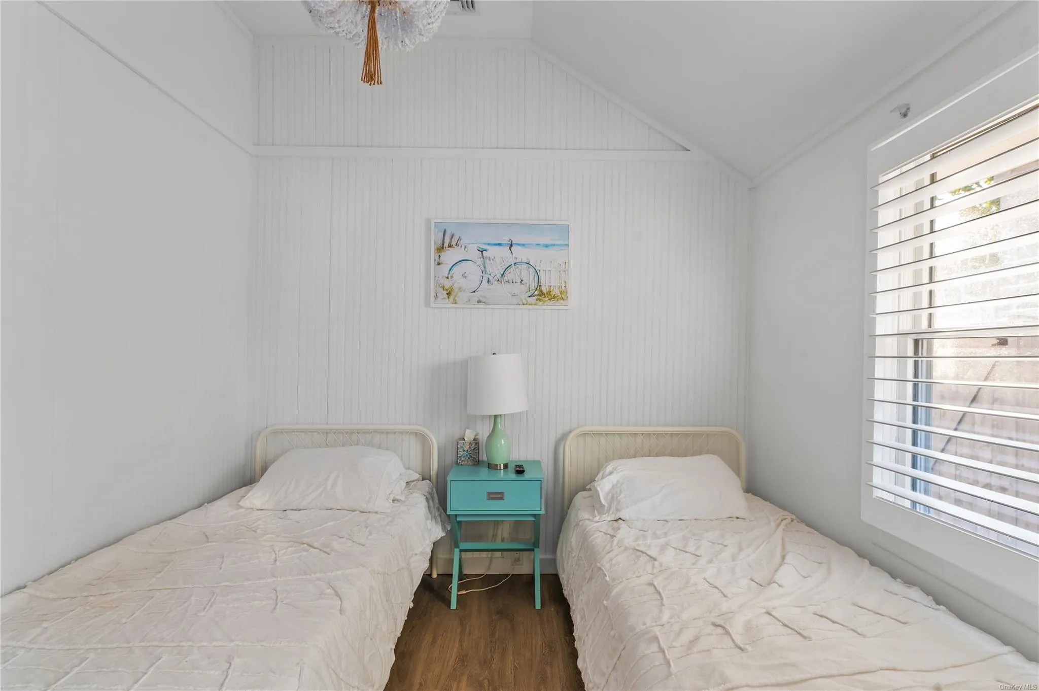 Bedroom with vaulted ceiling and hardwood / wood-style floors Bedroom with vaulted ceiling and hardwood / wood-style floors