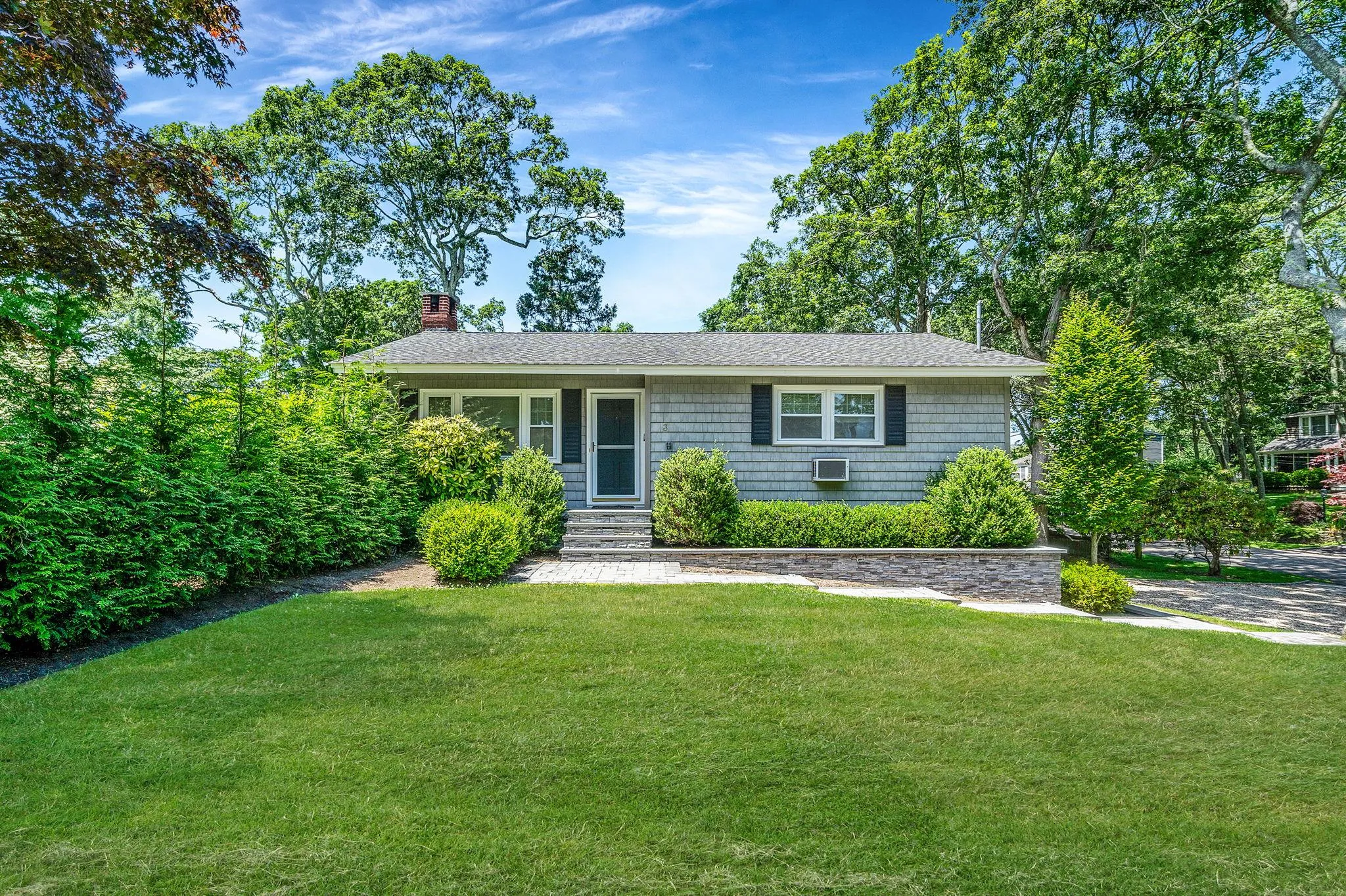 View of front facade featuring a front yard, a chimney, and roof with shingles View of front facade featuring a front yard, a chimney, and roof with shingles