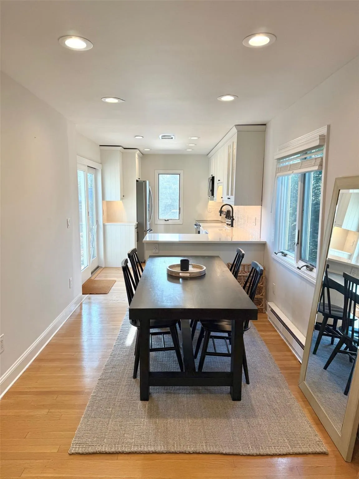 Dining room featuring light hardwood / wood-style floors and baseboard heating Dining room featuring light hardwood / wood-style floors and baseboard heating