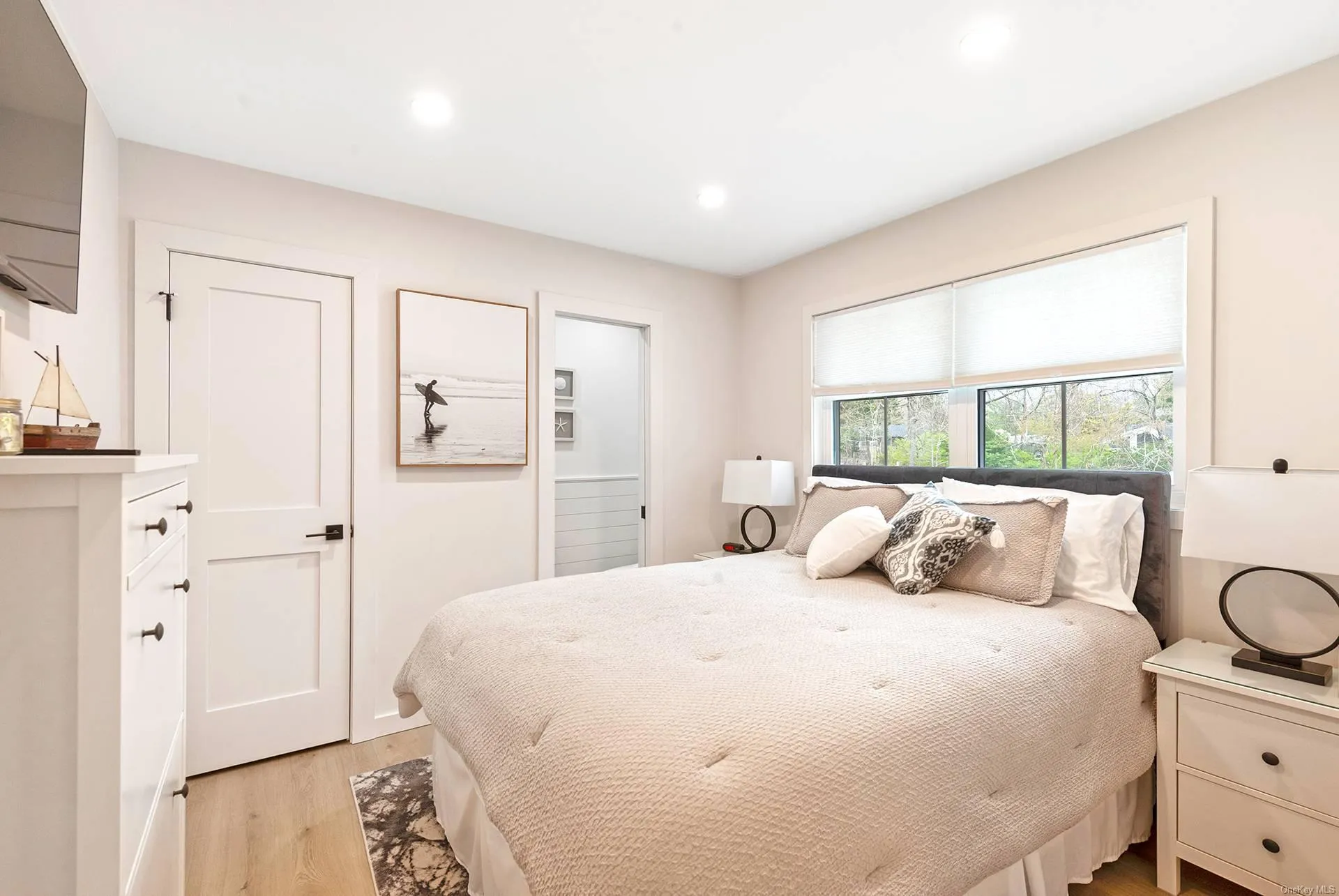 Bedroom with light wood-style floors and recessed lighting Bedroom with light wood-style floors and recessed lighting