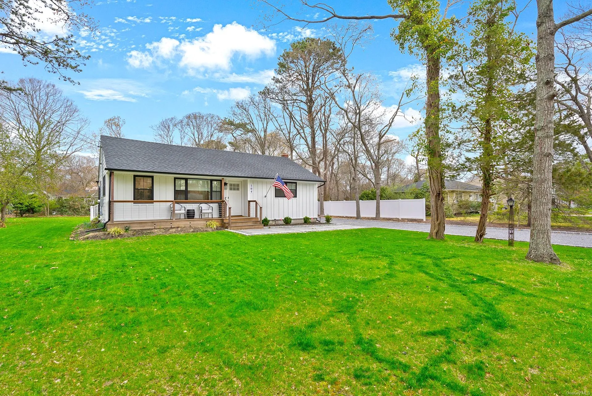 Rear view of property featuring board and batten siding, a porch, a chimney, and a shingled roof Rear view of property featuring board and batten siding, a porch, a chimney, and a shingled roof