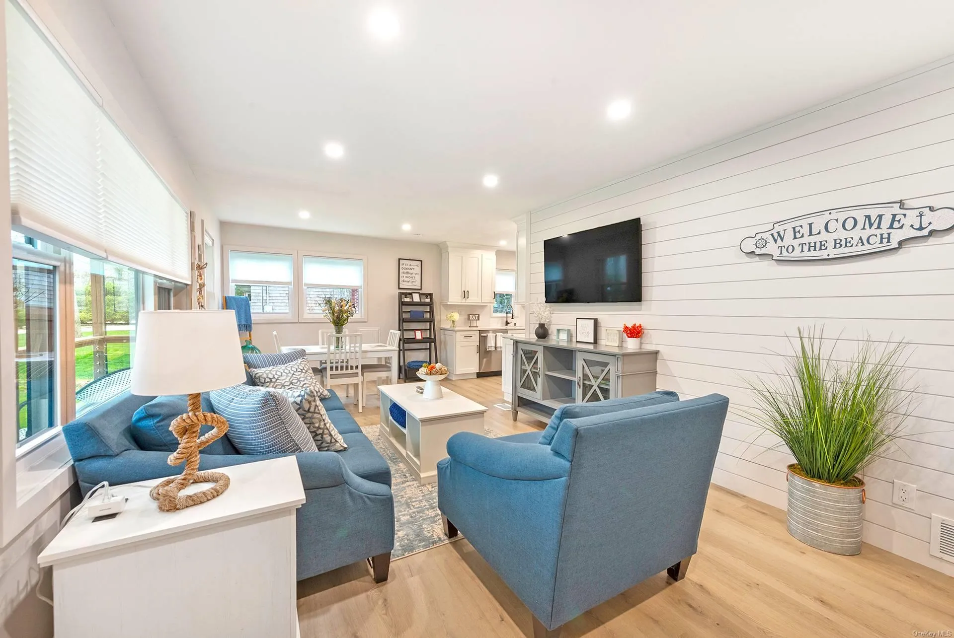 Living room featuring light wood-type flooring and recessed lighting Living room featuring light wood-type flooring and recessed lighting