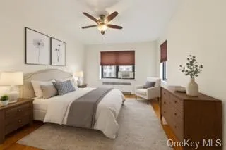 Bedroom with wood finished floors and a ceiling fan Bedroom with wood finished floors and a ceiling fan