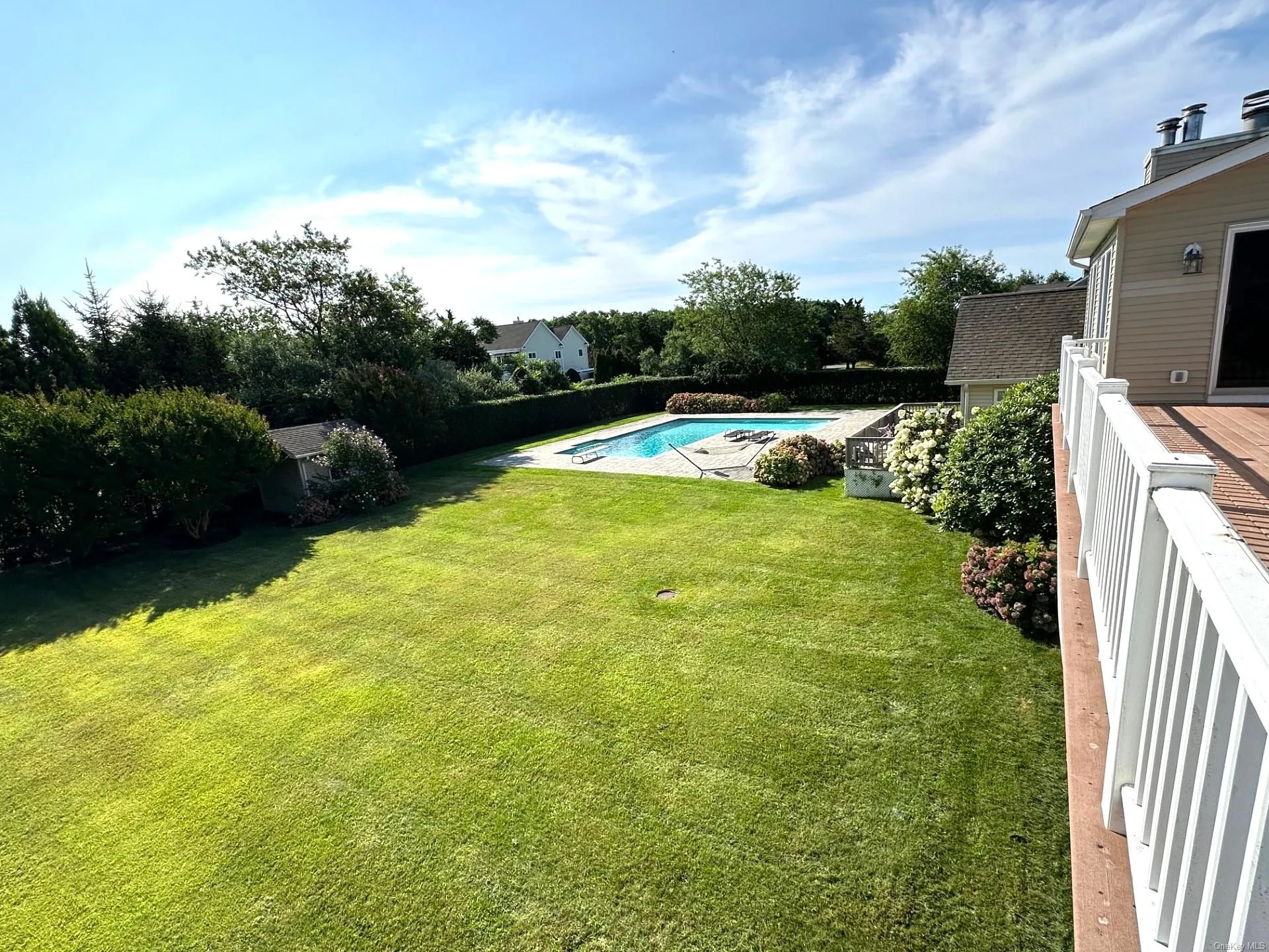 View of yard with a wooden deck and a fenced in pool View of yard with a wooden deck and a fenced in pool