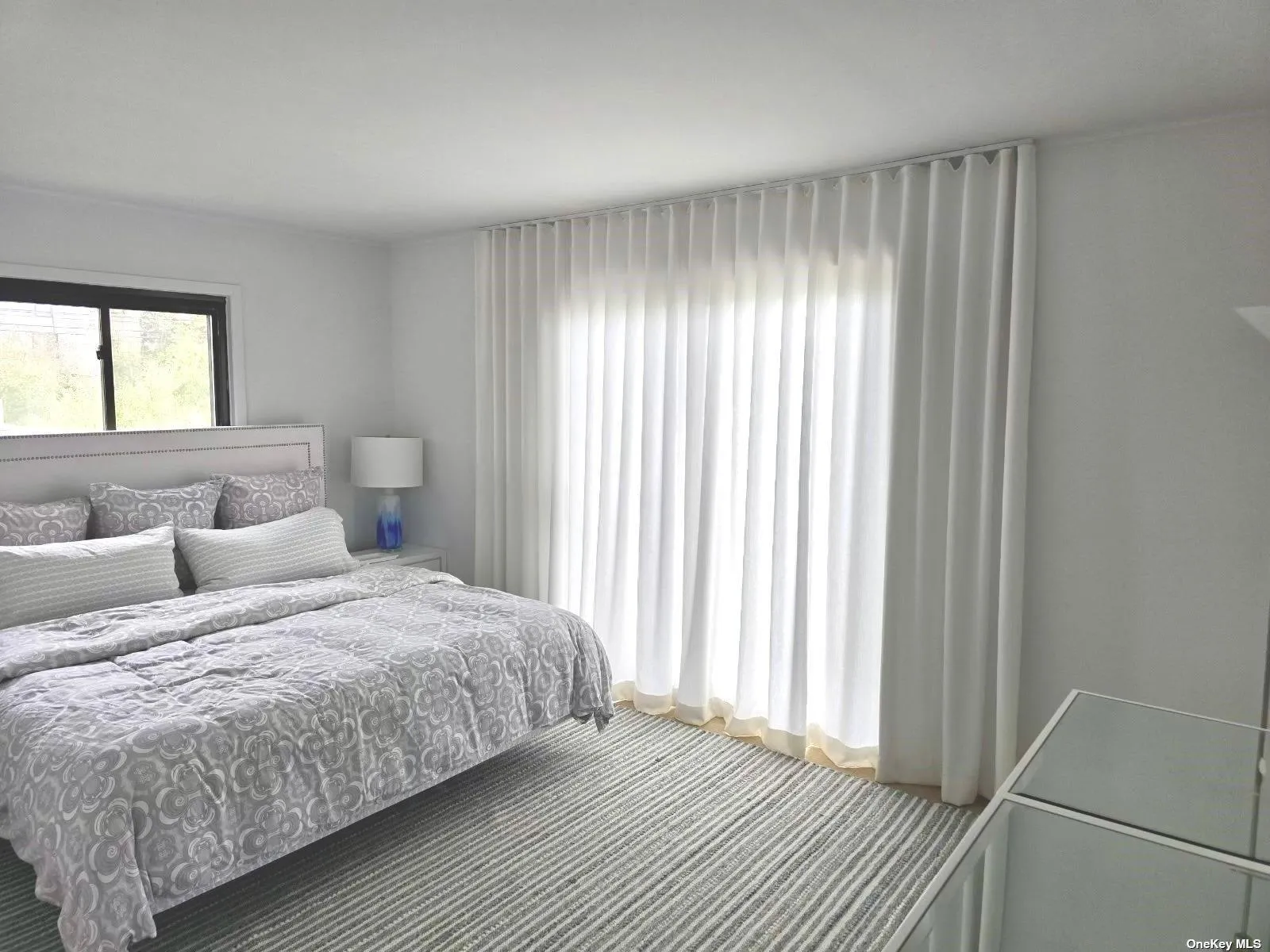 First floor king bedroom with sliders to wrap around deck First floor king bedroom with sliders to wrap around deck