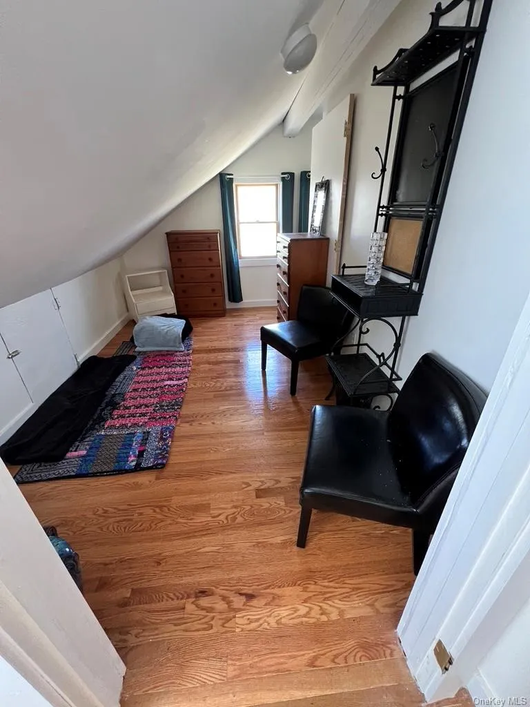 Bedroom featuring light wood-style floors and lofted ceiling Bedroom featuring light wood-style floors and lofted ceiling