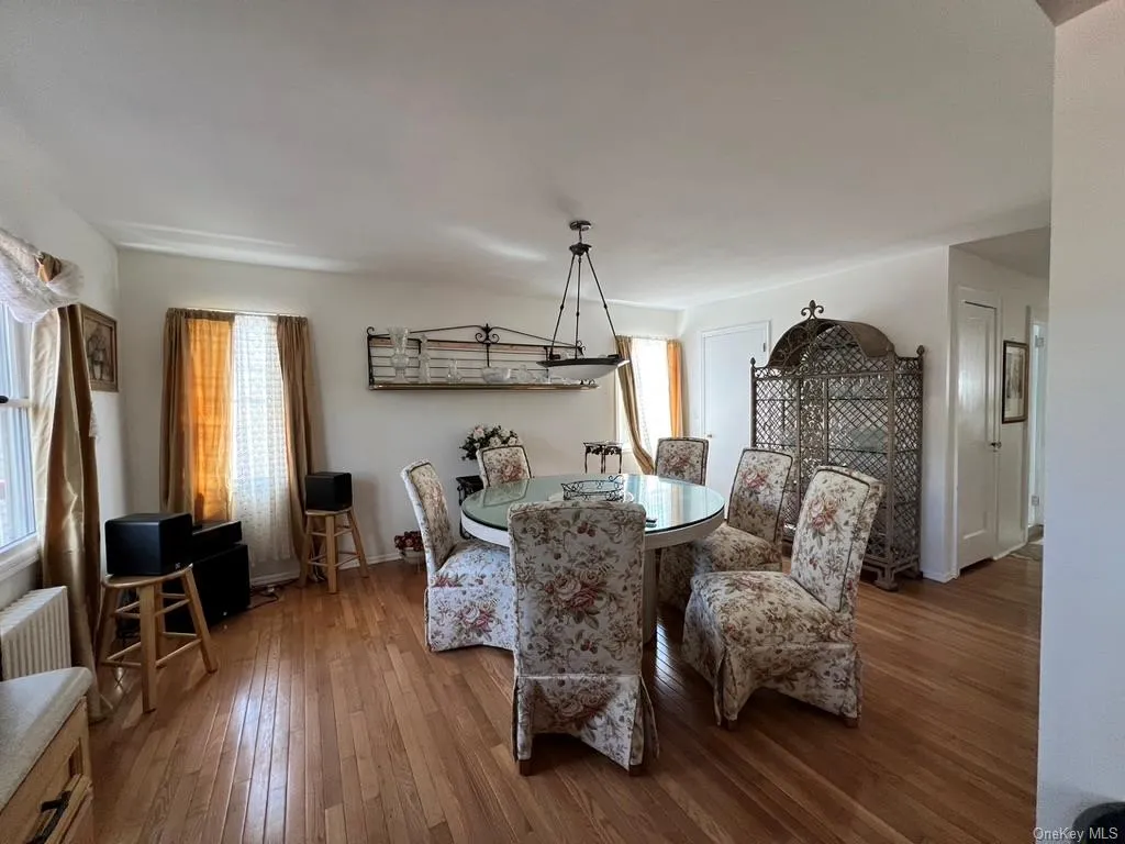 Dining room with radiator and wood-type flooring Dining room with radiator and wood-type flooring