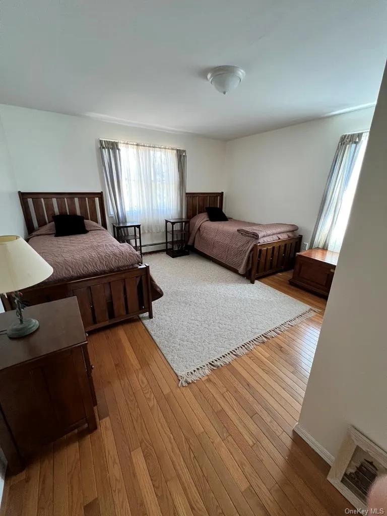 Bedroom featuring wood-type flooring and visible vents Bedroom featuring wood-type flooring and visible vents