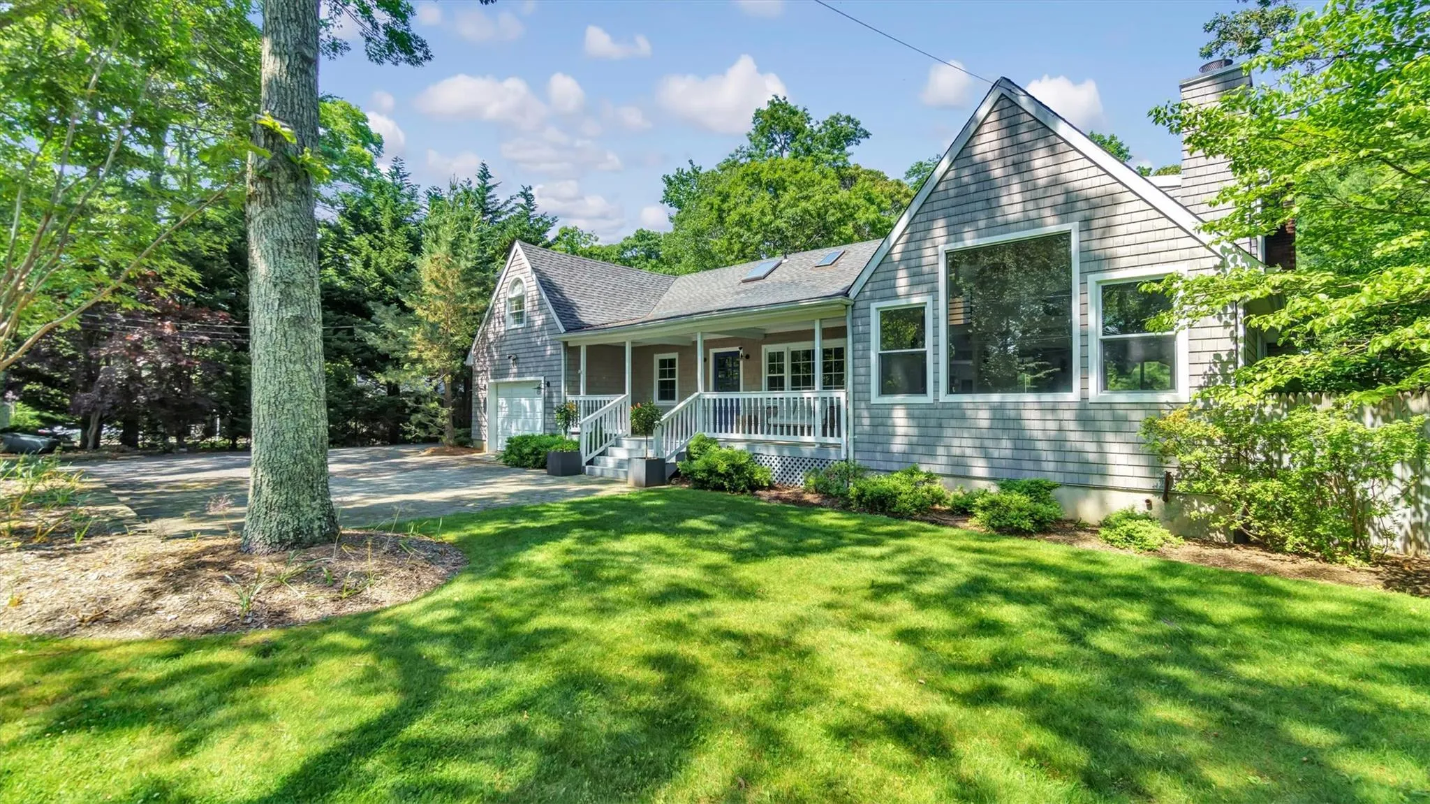 View of front of house with covered porch, and front lawn. View of front of house with covered porch, and front lawn.
