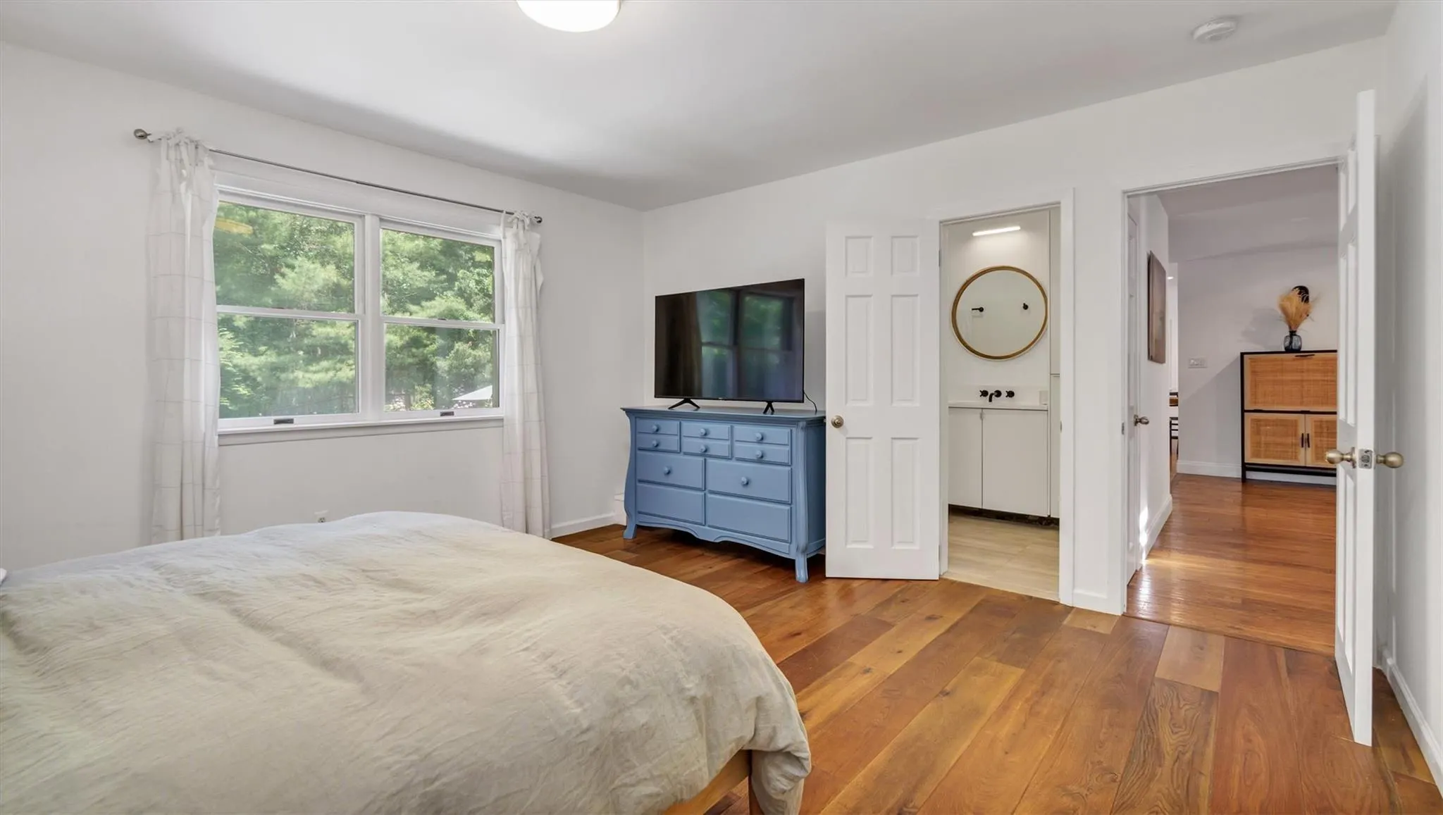 Bedroom with wood-type flooring and en-suite full bathroom. Bedroom with wood-type flooring and en-suite full bathroom.