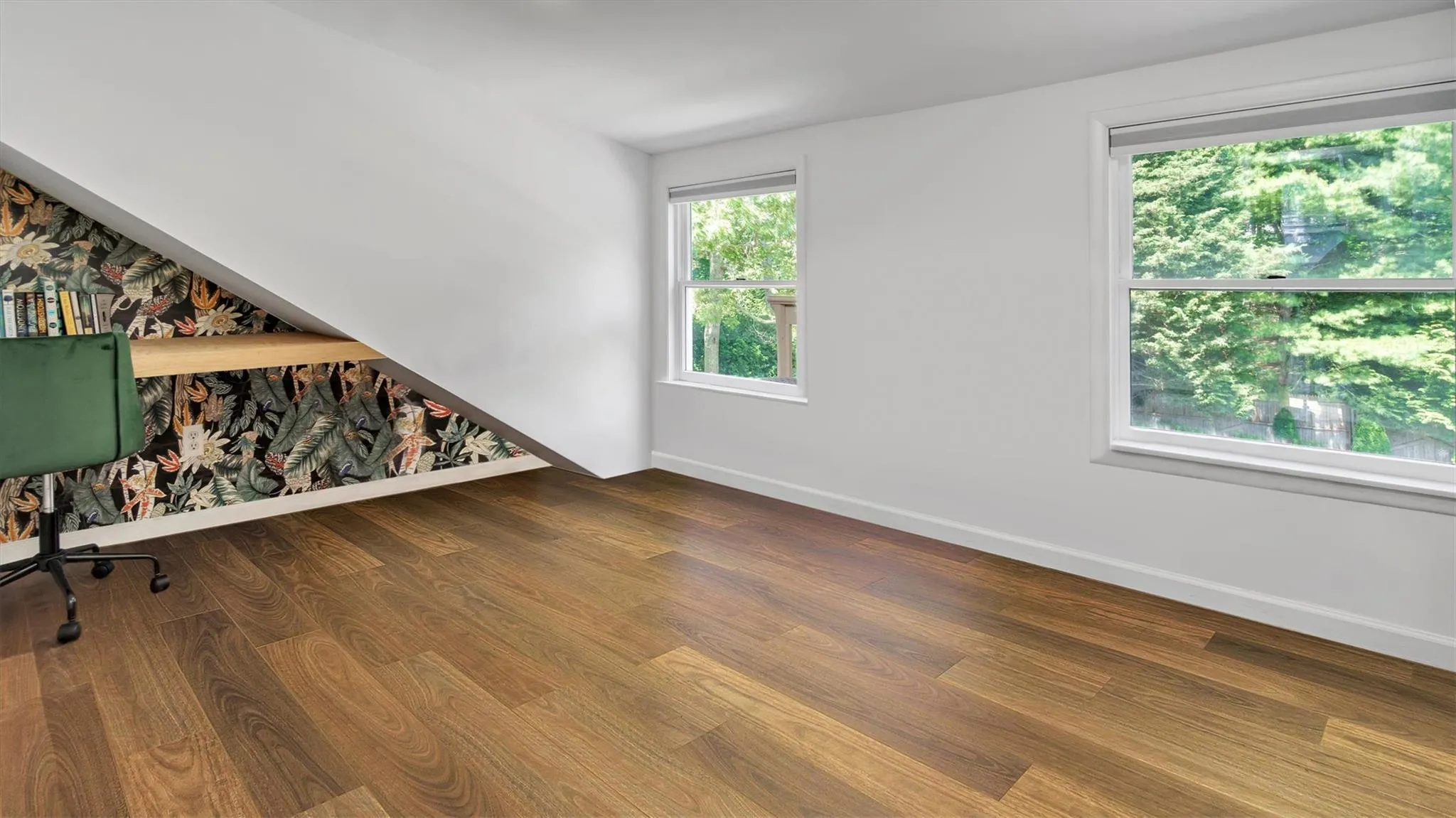 Room with desk and dark wood-style floors Room with desk and dark wood-style floors