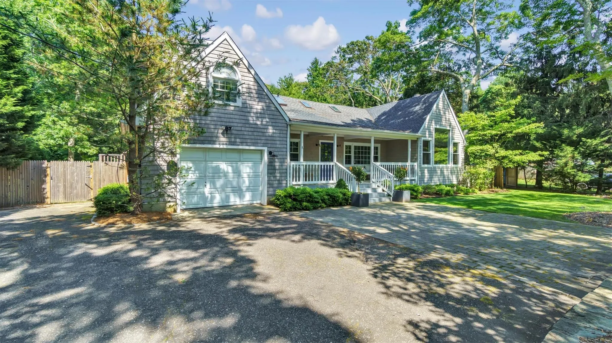 View of front of house featuring a porch, and asphalt driveway. View of front of house featuring a porch, and asphalt driveway.