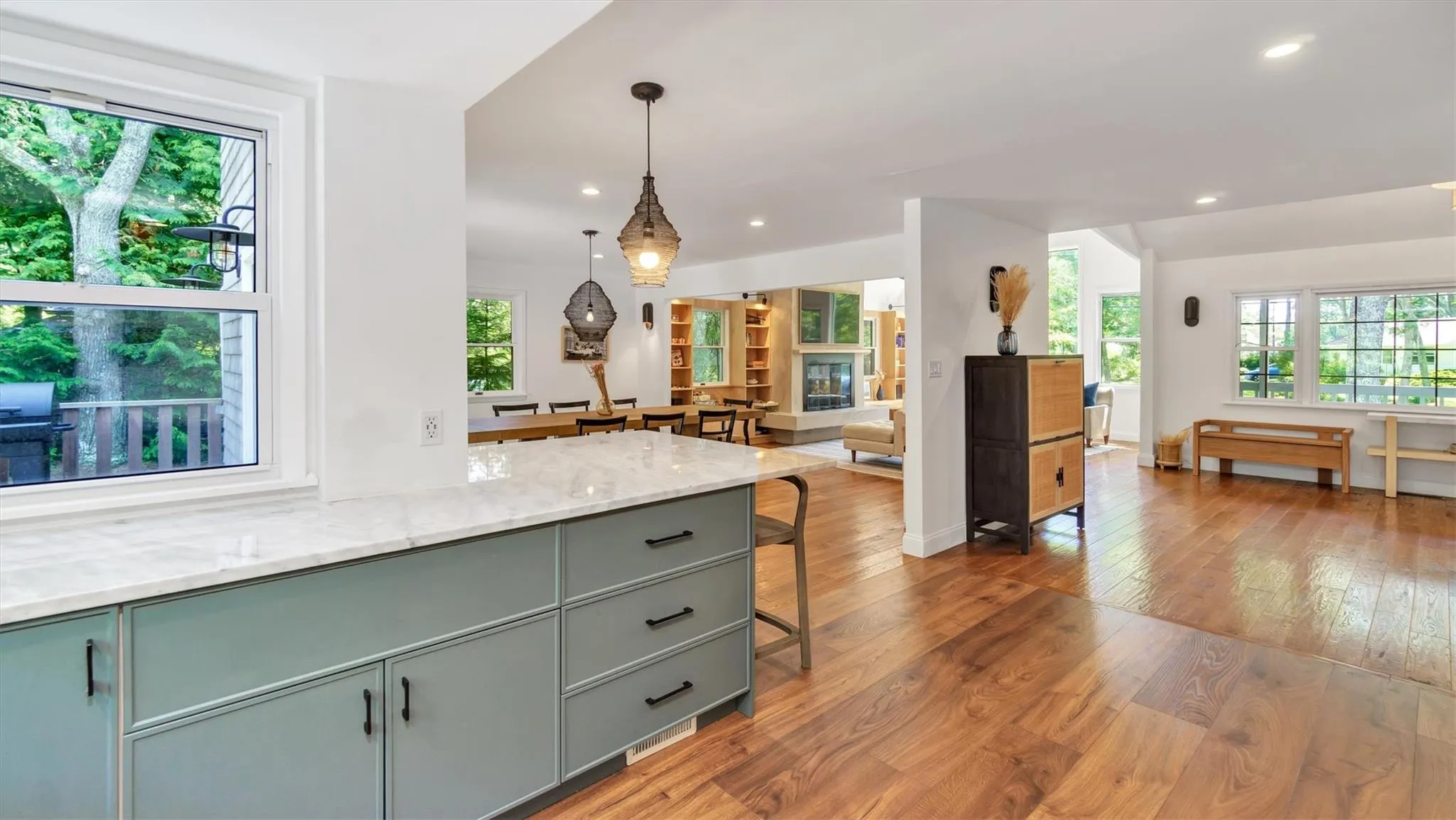 Kitchen with wood style finished floors, recessed lighting, hanging light fixtures, and open floor plan. Kitchen with wood style finished floors, recessed lighting, hanging light fixtures, and open floor plan.