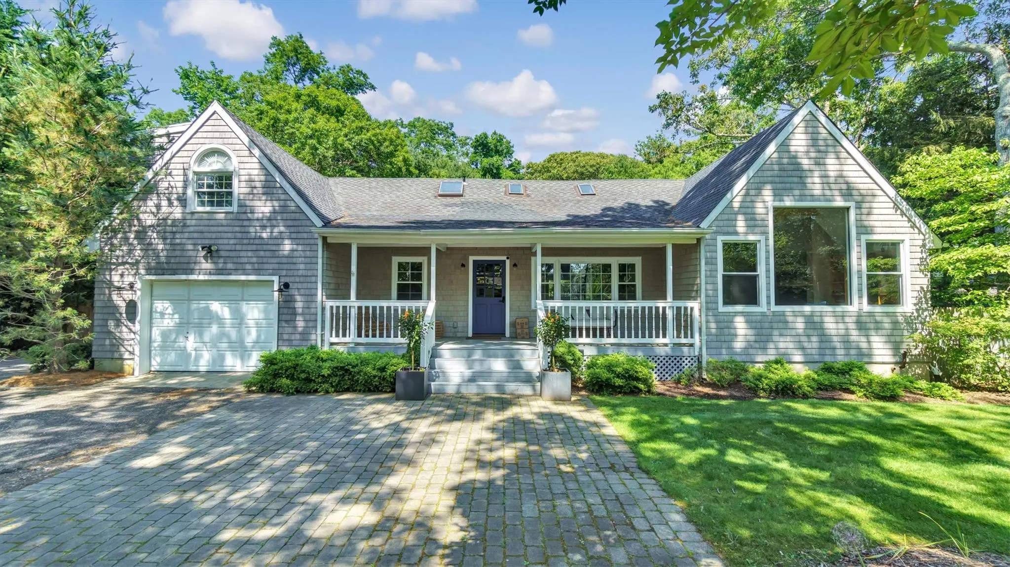 View of front of house with covered porch, a front yard, and driveway View of front of house with covered porch, a front yard, and driveway