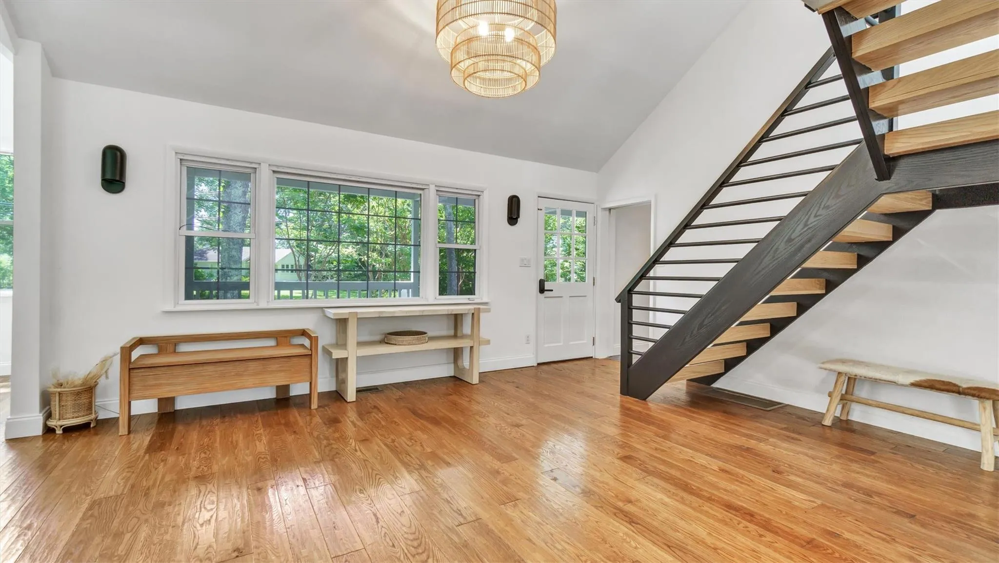 Entrance foyer featuring stairs, wood-type flooring, a chandelier, and high ceiling. Entrance foyer featuring stairs, wood-type flooring, a chandelier, and high ceiling.