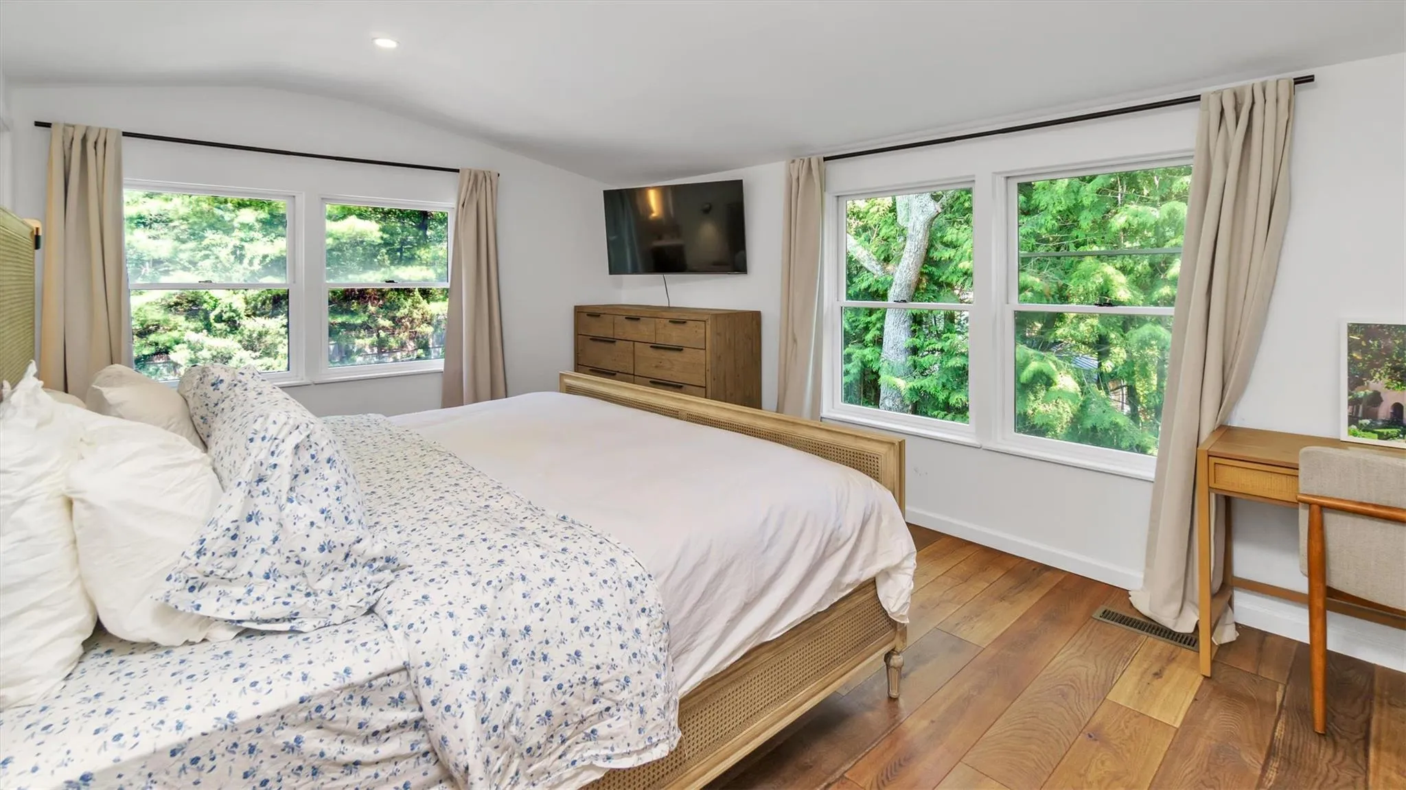 Bedroom with vaulted ceiling, hardwood / wood-style floors, recessed lighting. Bedroom with vaulted ceiling, hardwood / wood-style floors, recessed lighting.
