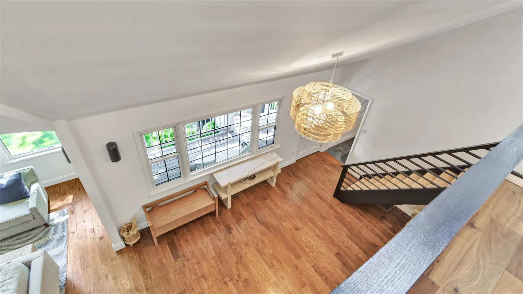 Stairway featuring high ceiling, and wood finished floors Stairway featuring high ceiling, and wood finished floors
