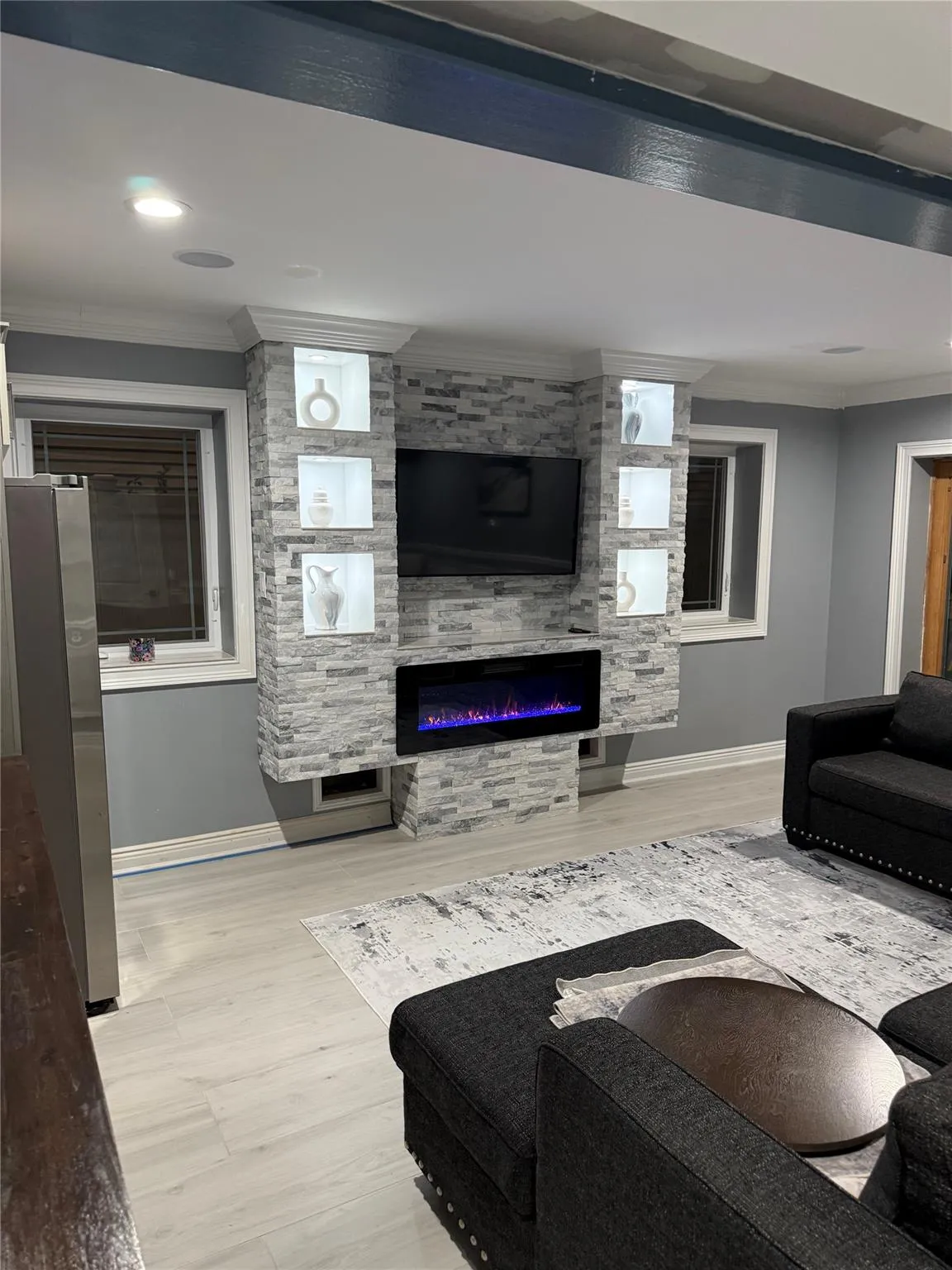 Living room with a large fireplace and ornamental molding Living room with a large fireplace and ornamental molding