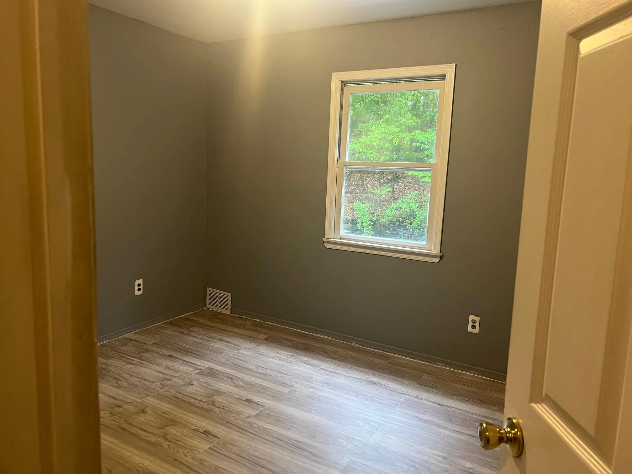 Unfurnished room featuring wood finished floors and baseboards Unfurnished room featuring wood finished floors and baseboards