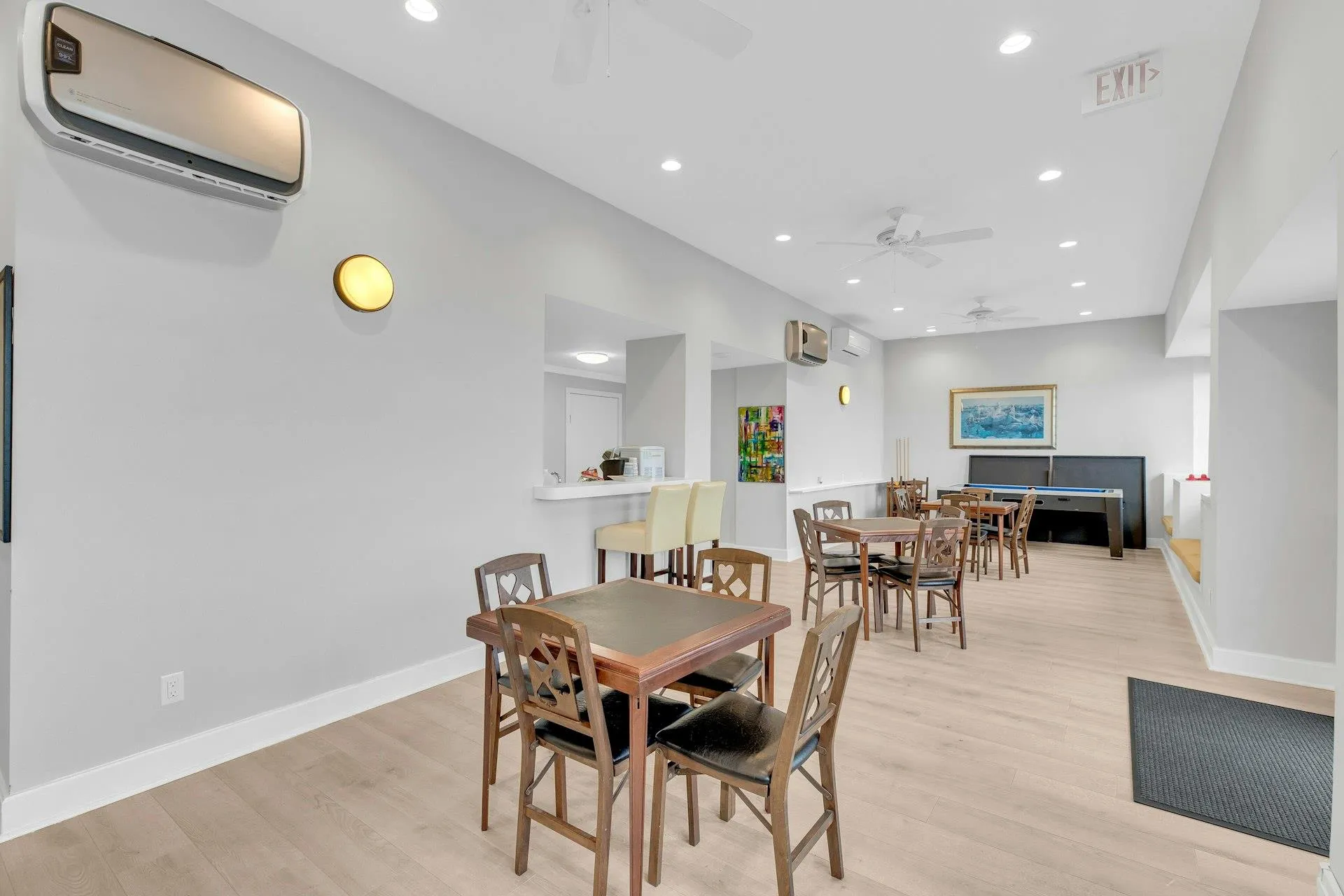 Dining area featuring an AC wall unit, ceiling fan, and light hardwood / wood-style floors Dining area featuring an AC wall unit, ceiling fan, and light hardwood / wood-style floors